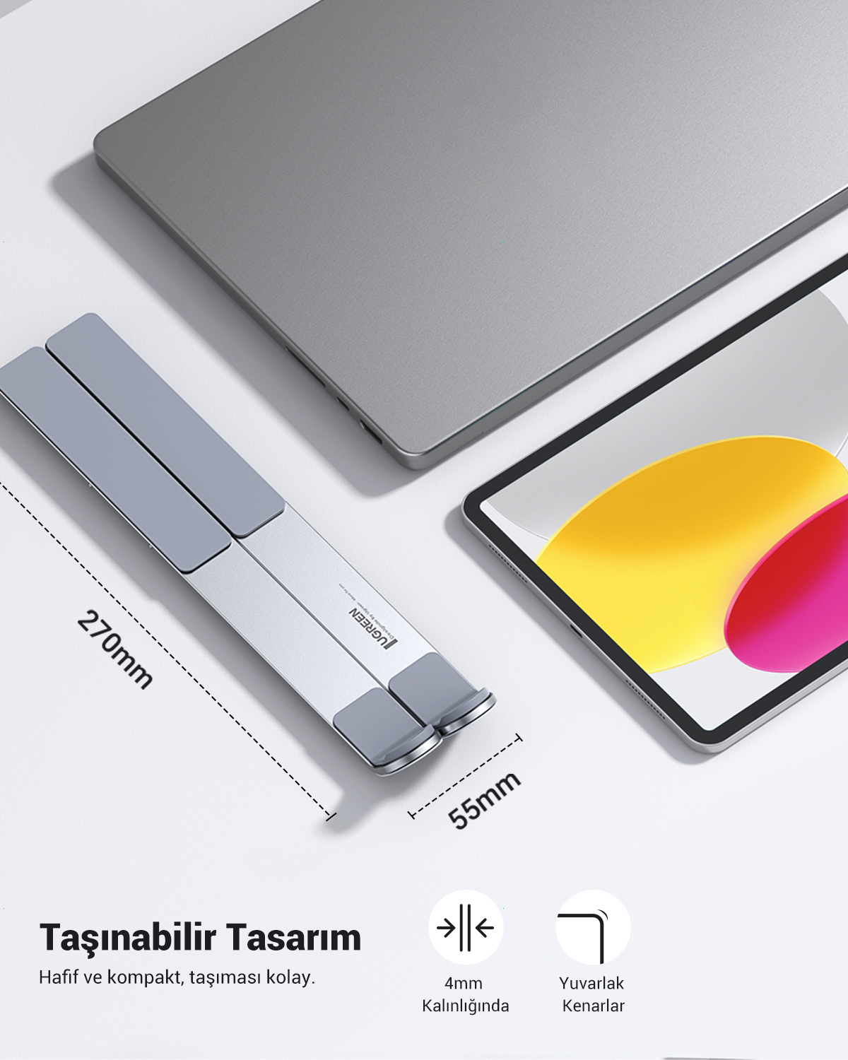 Gümüş renkli dizüstü bilgisayar standı, tablet ve dizüstü bilgisayar yanında.
