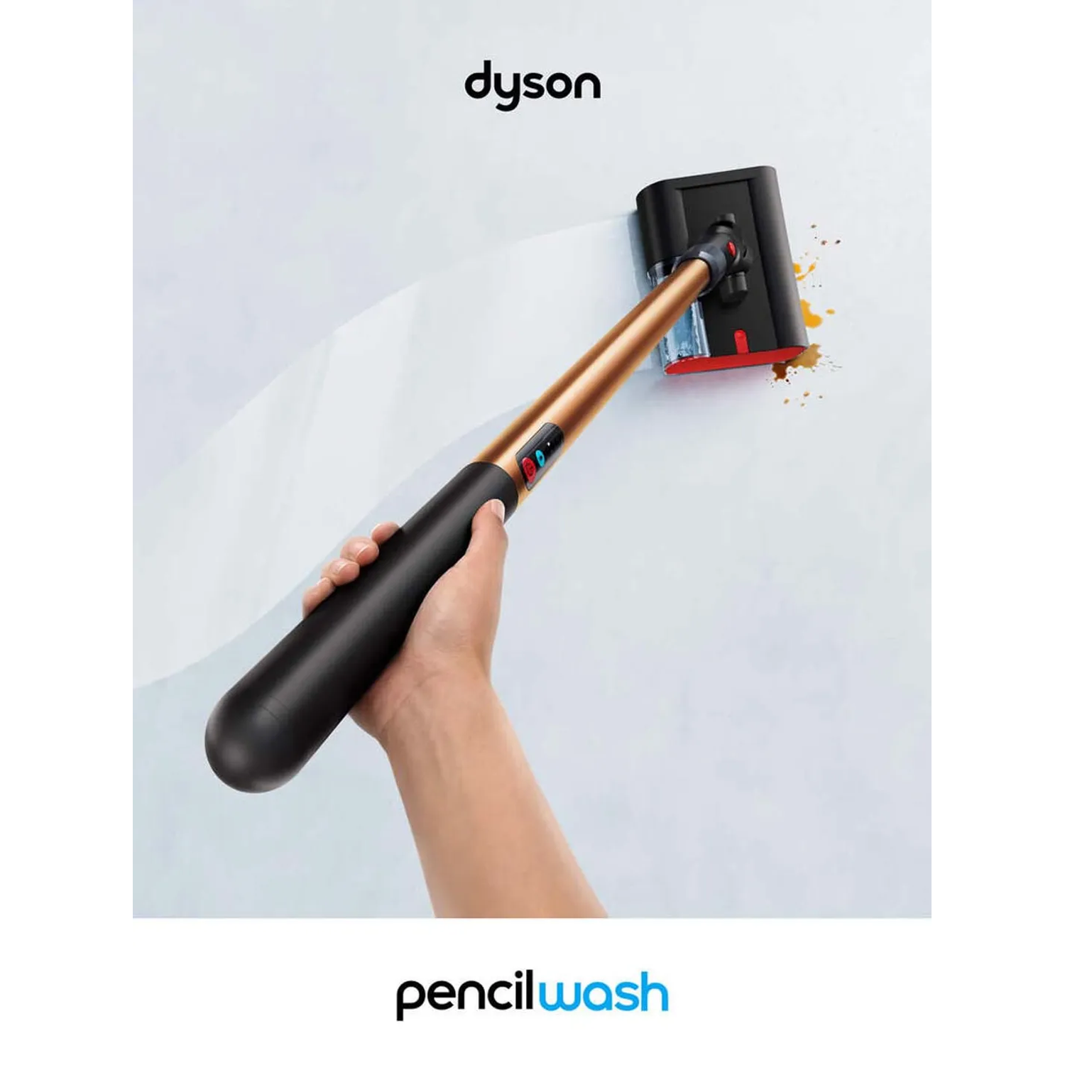 A hand holds a Dyson cleaner with a gold pole, cleaning brown stains off a white wall.