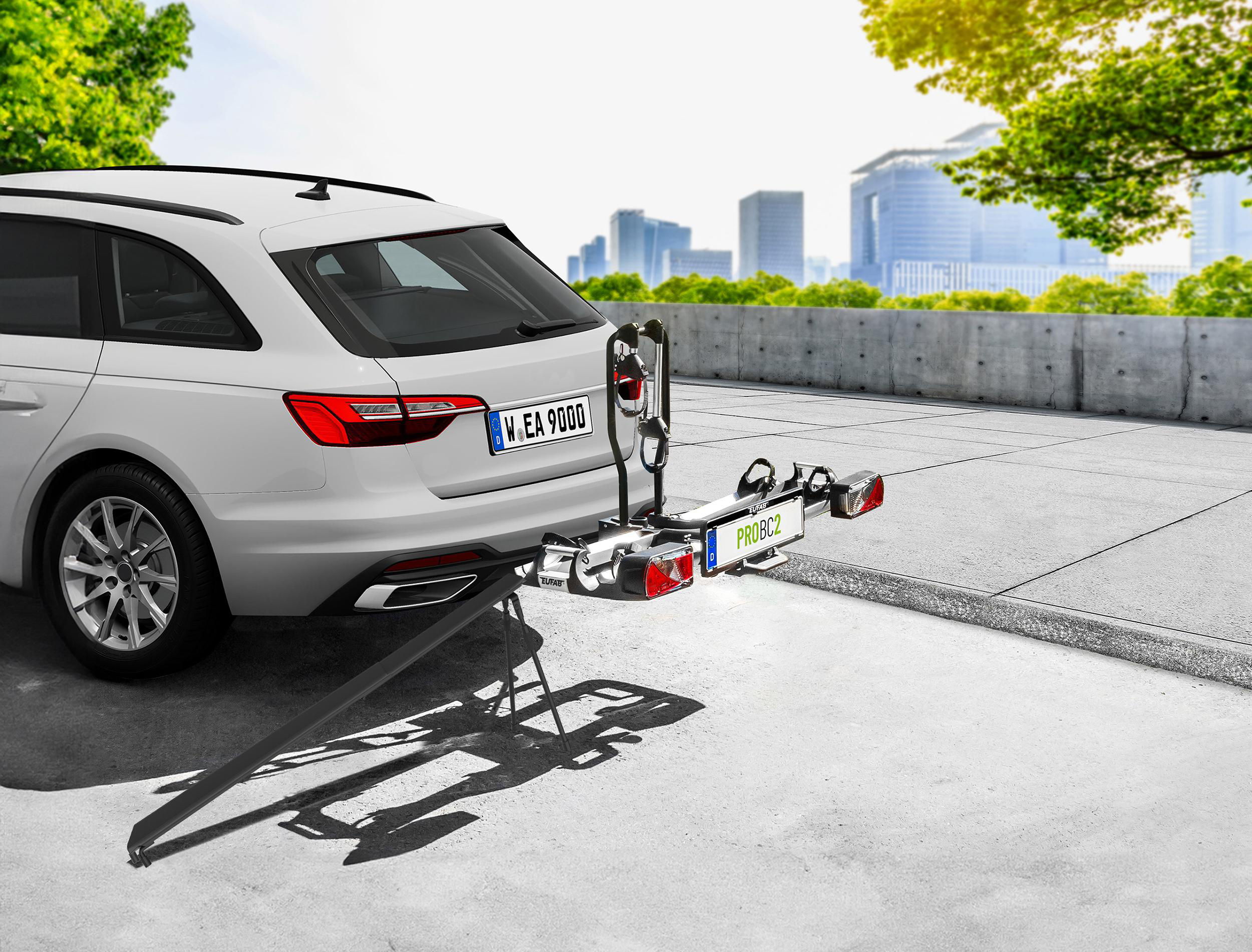 Ein weißer Audi Avant mit Fahrradträger, Nummernschild W.EA 9000.