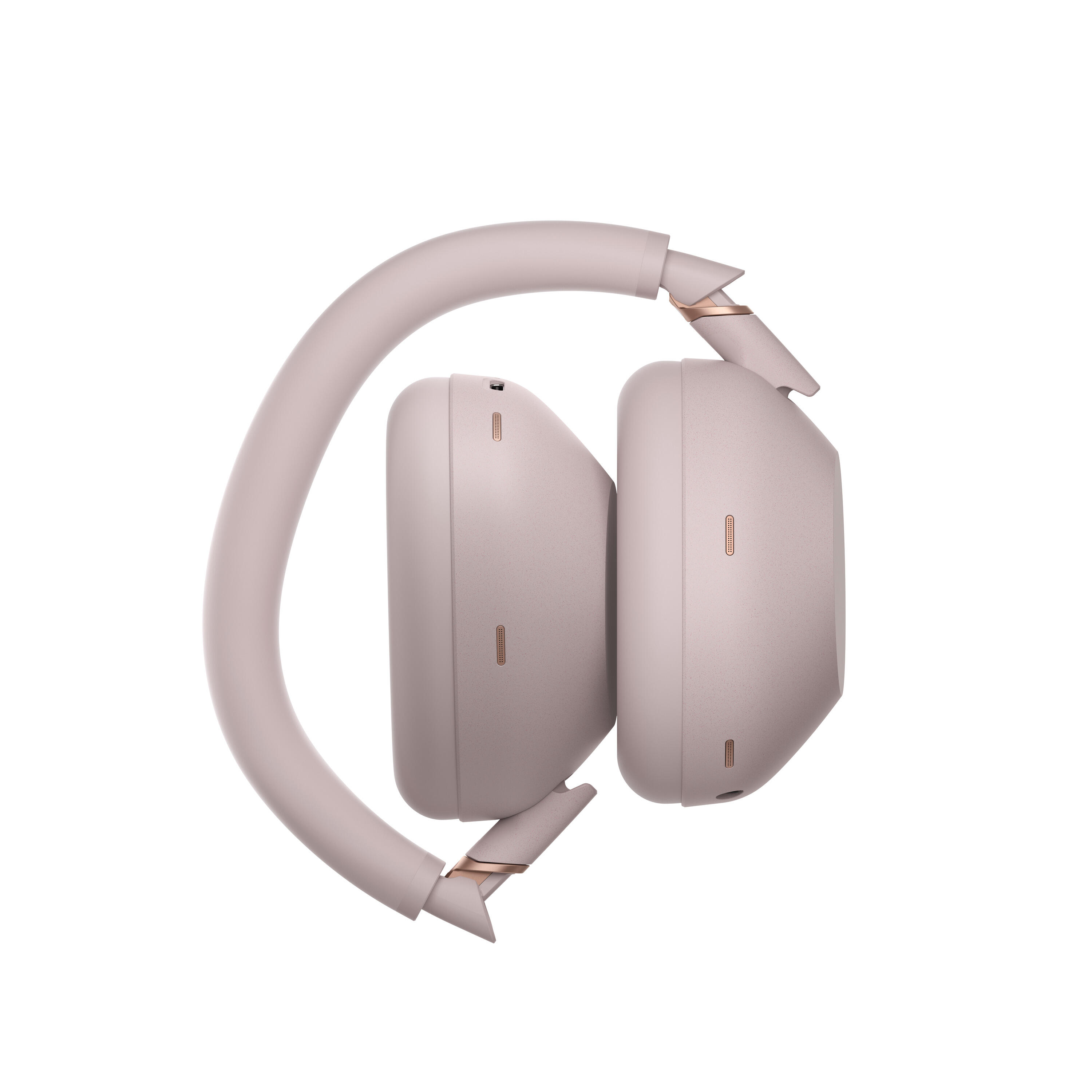 Unos auriculares rosa empolvado con detalles dorados, plegados.