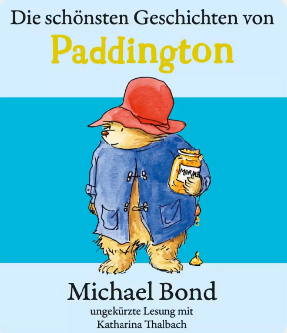 Paddington Bär in blauem Mantel und rotem Hut hält Marmeladenglas.