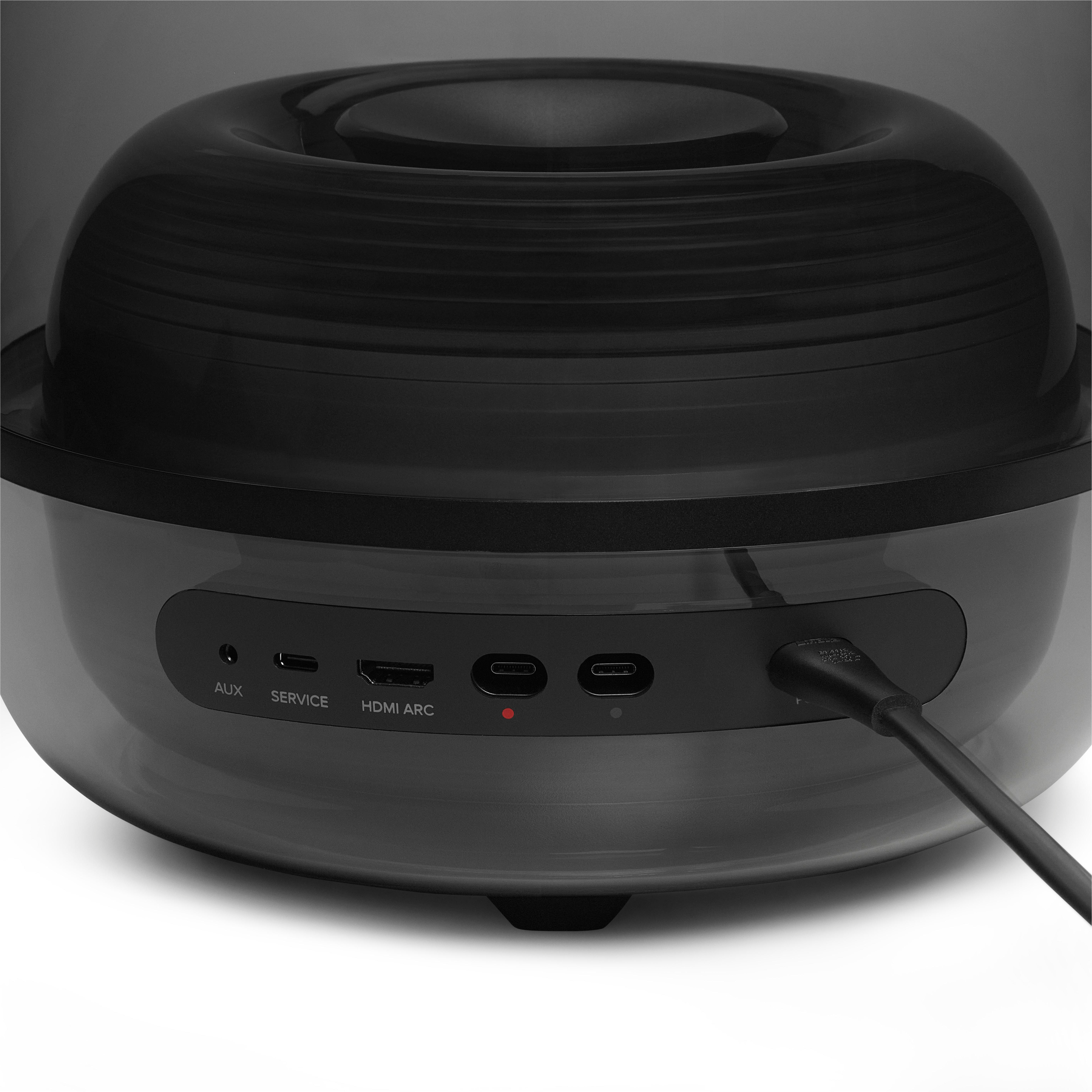 Nahaufnahme der Anschlüsse eines schwarzen Geräts mit AUX, SERVICE, HDMI ARC und USB-C.
