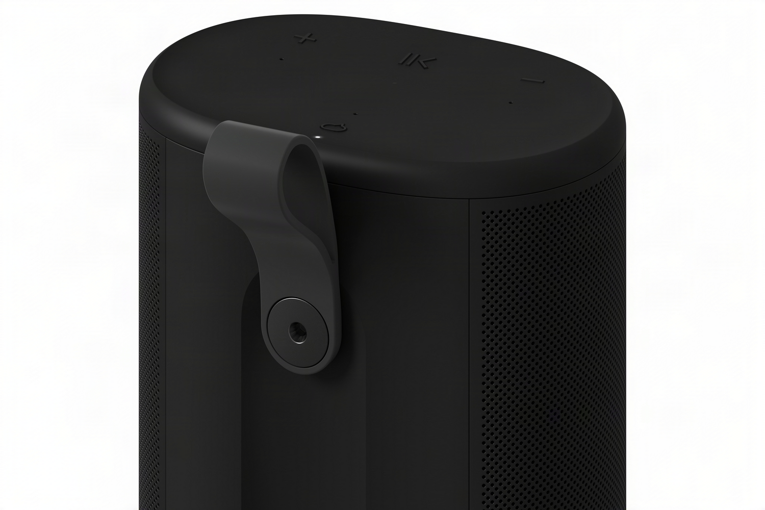 Altavoz cilíndrico negro con asa de transporte y botones superiores.