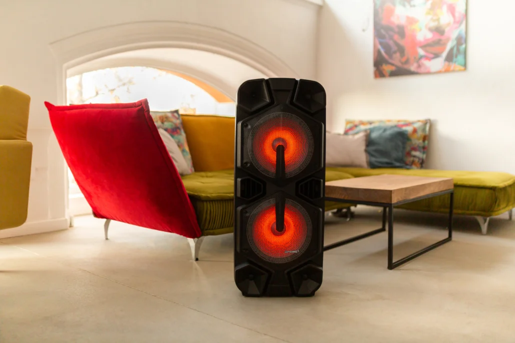 Czarny głośnik z czerwonymi światłami jest na pierwszym planie.