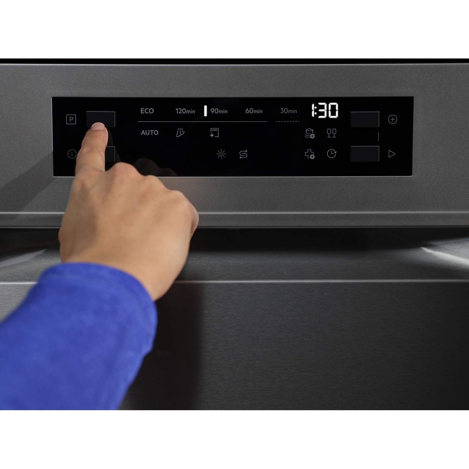 Una mano preme un pulsante su un pannello di controllo scuro con display digitali.