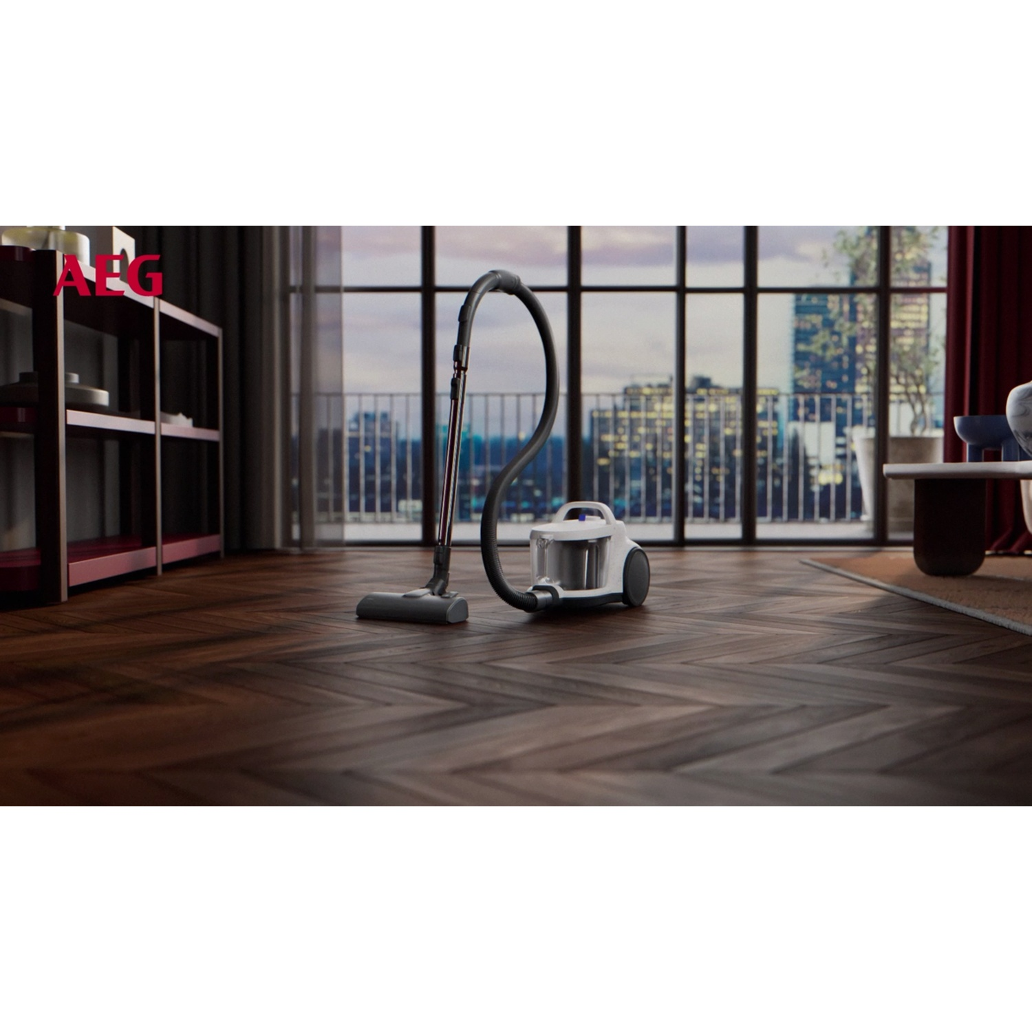 A white vacuum cleaner sits on a wooden floor in front of a window with a city view.