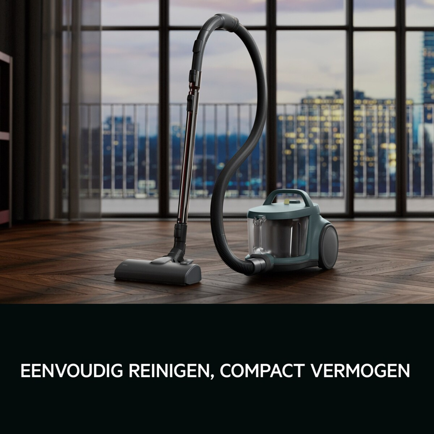 A teal vacuum cleaner sits on a wooden floor in front of a city view window.