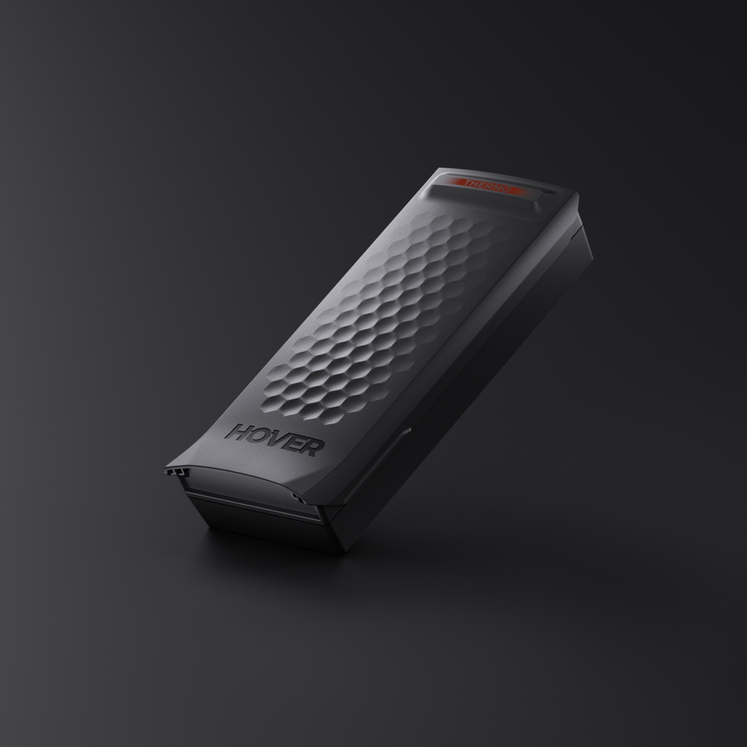 Black rectangular container with honeycomb pattern and red light detail.
