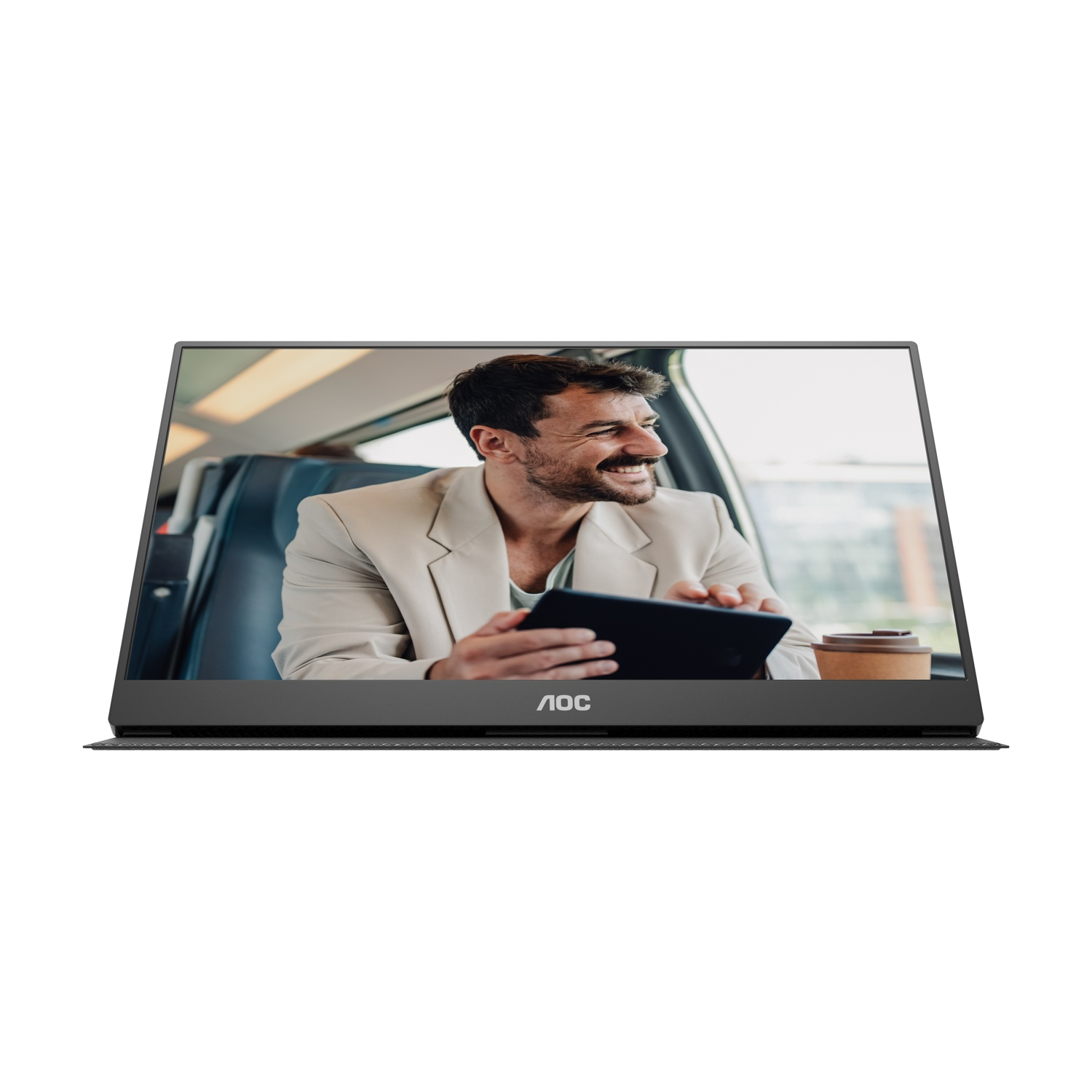 Uomo sul treno tiene tablet, indossa giacca. Tazza di caffè vicina.