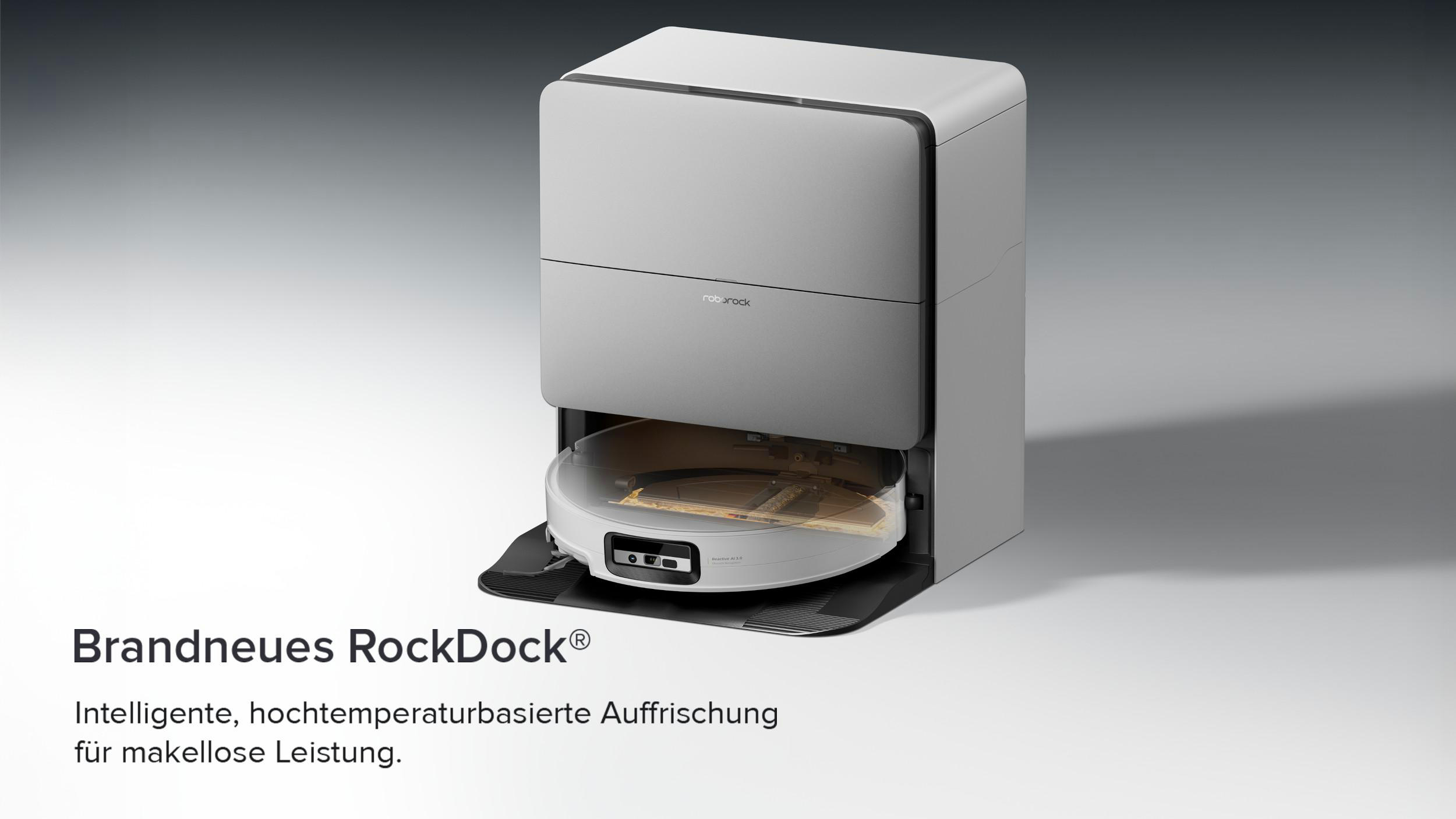 Ein grauer Roboterstaubsauger mit Ladestation auf grauem Hintergrund.