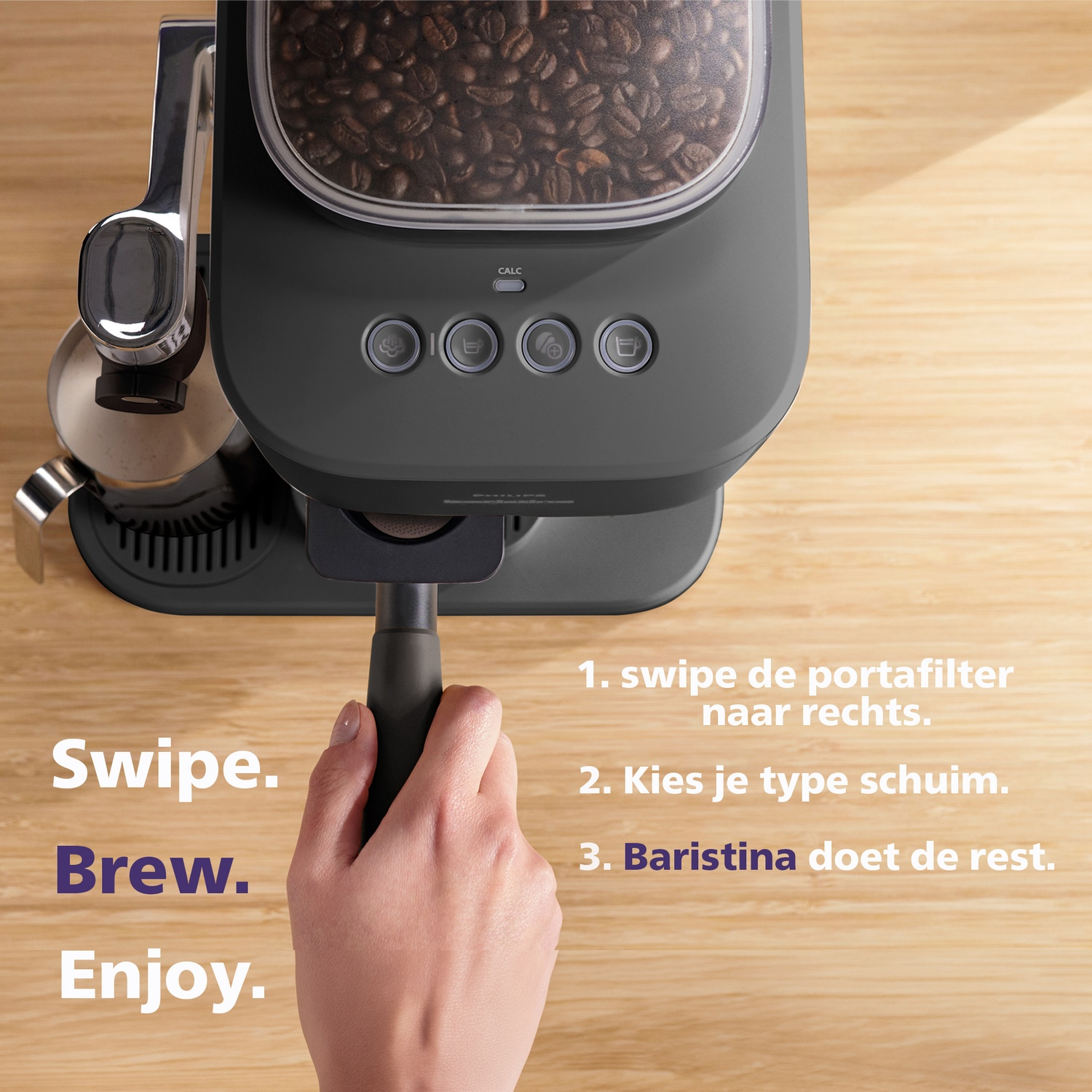 A hand holds the portafilter of a coffee machine with a bean hopper.