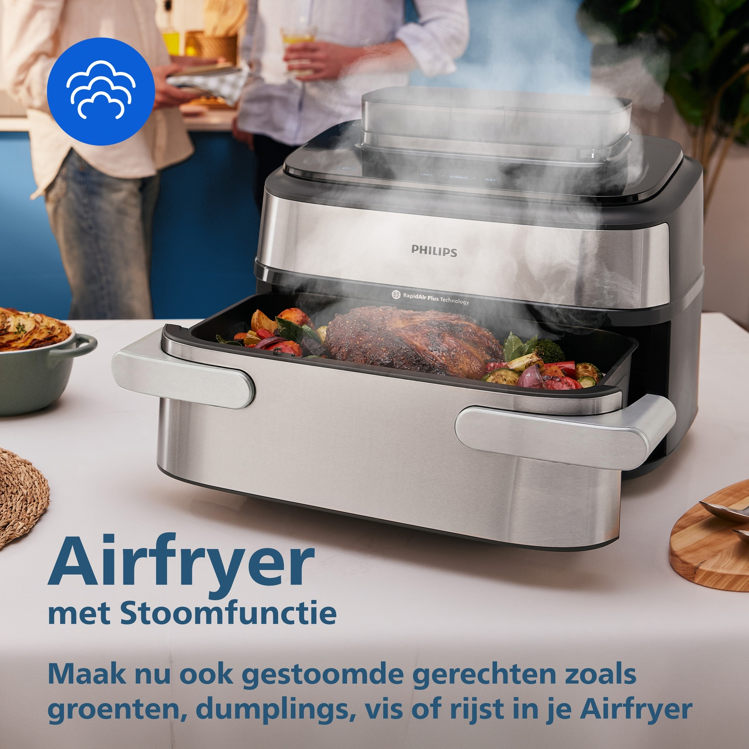 A Philips airfryer with steam function cooking meat and vegetables.