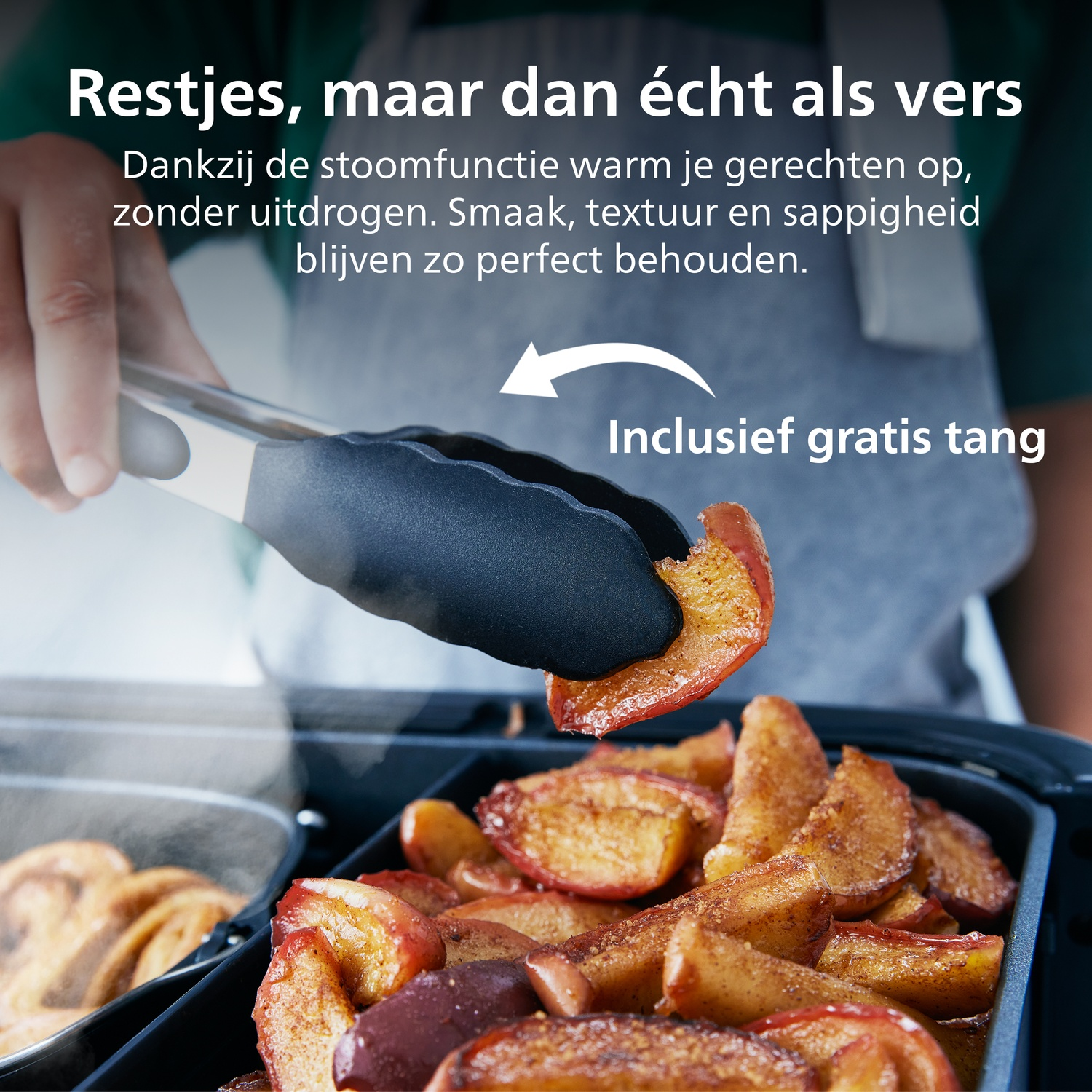 Tongs pick up a slice of baked apple from a container of fruit.