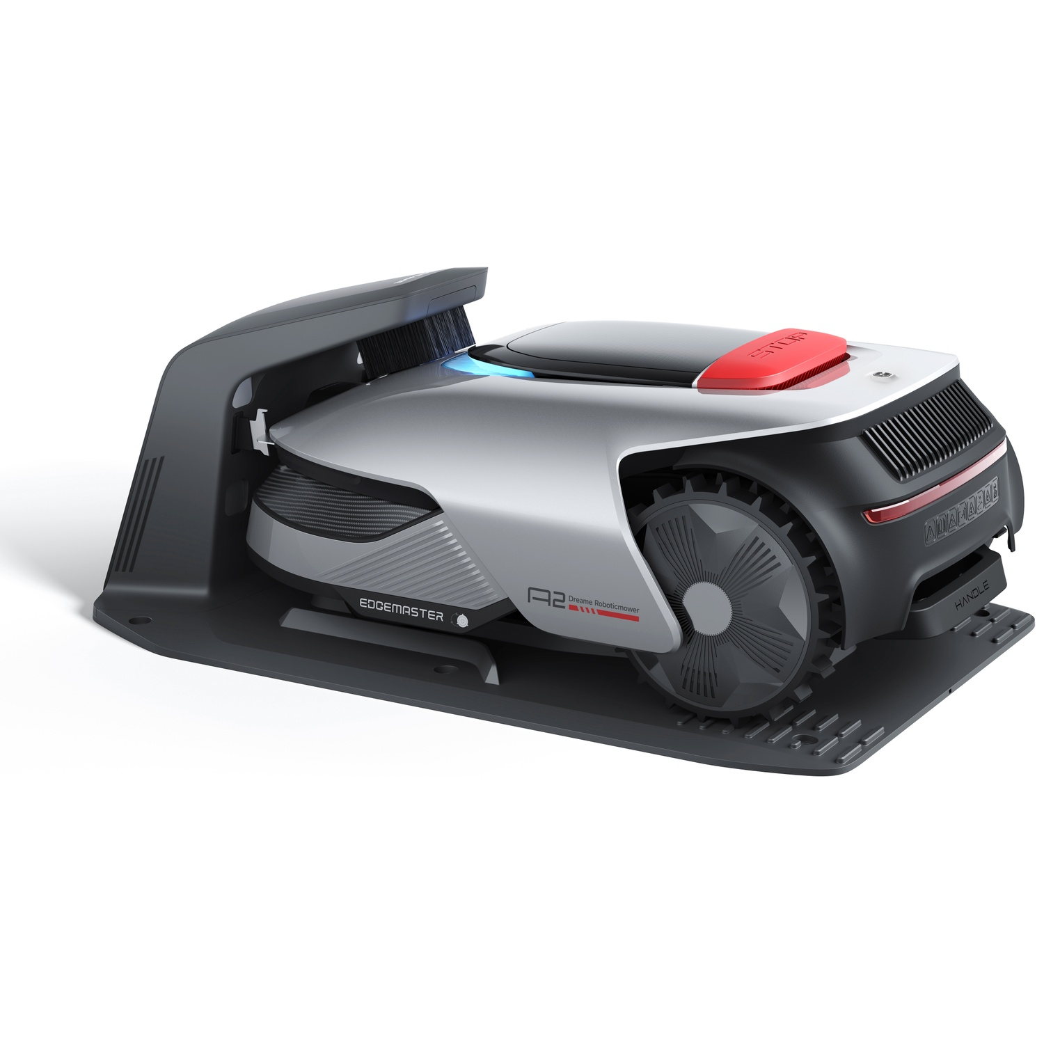 A silver robotic lawn mower with a black charging station and a red stop button.