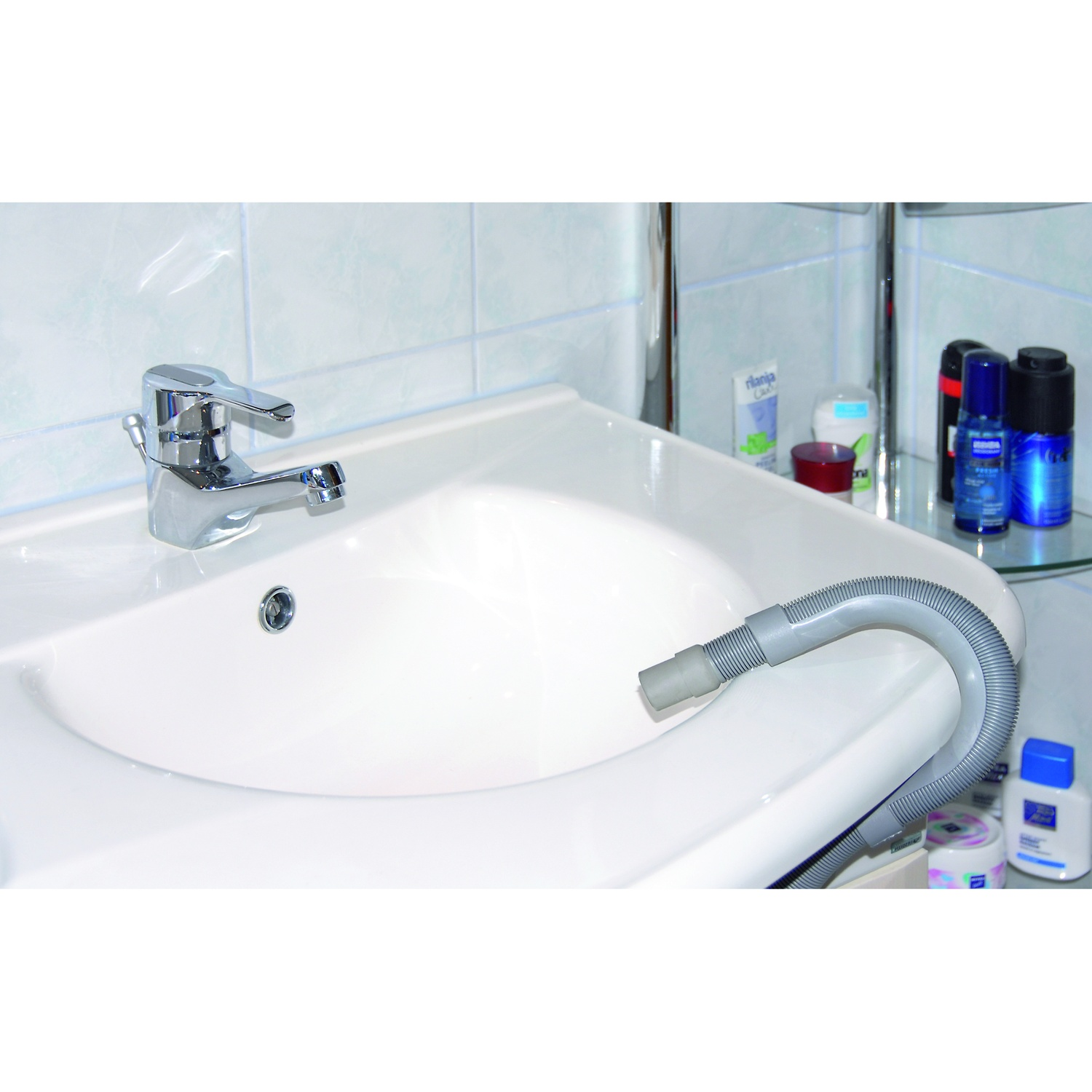 A silver faucet above a white sink with a gray hose.