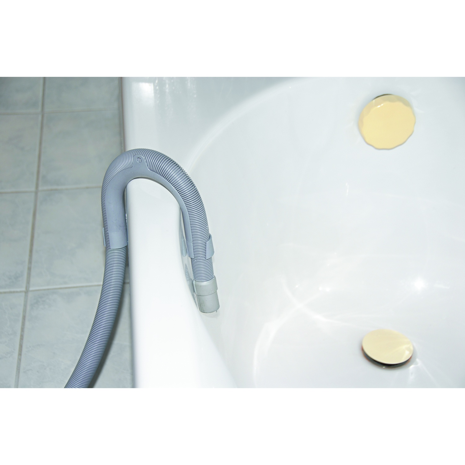 Gray hose in a white bathtub with two gold drains.