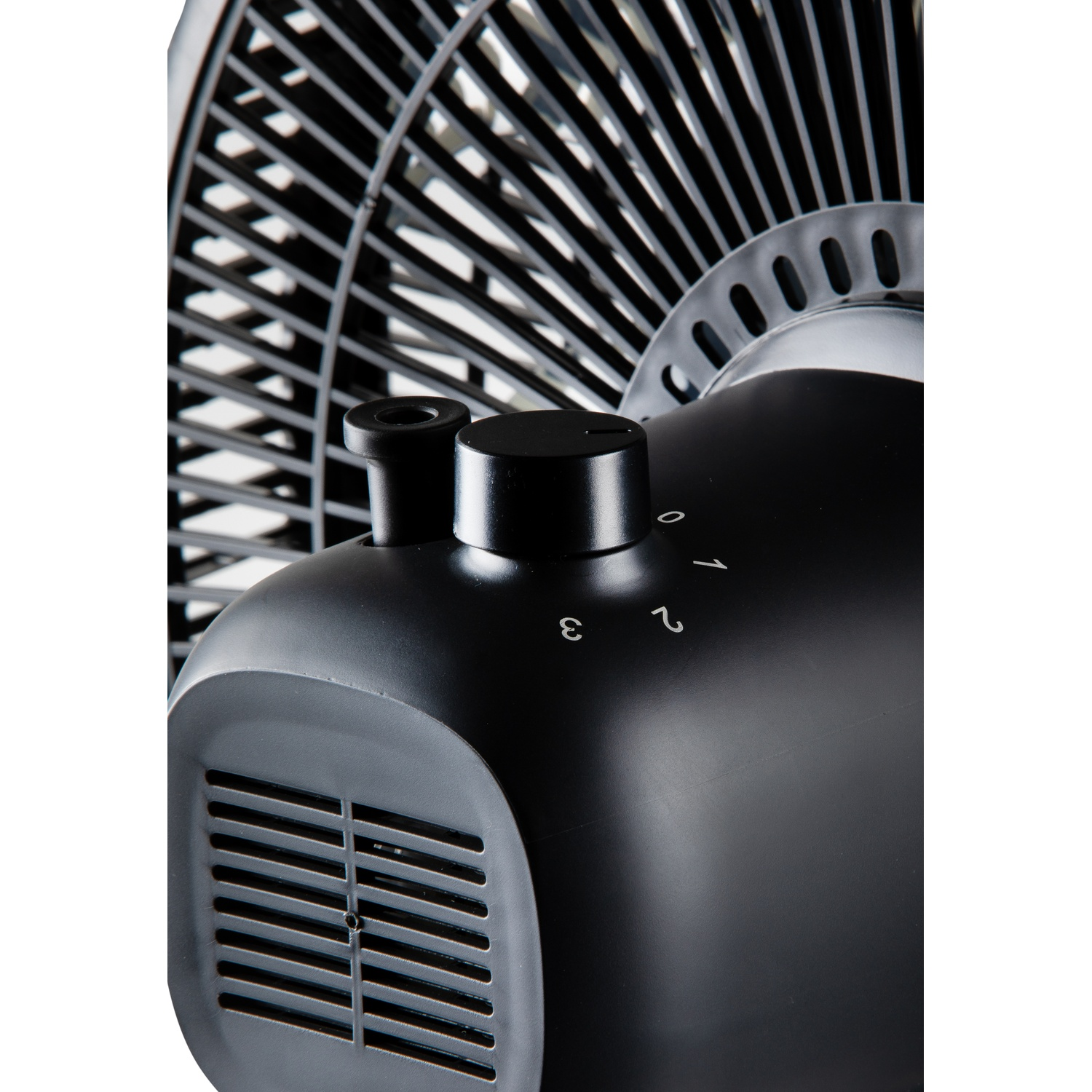 Close-up of a black fan, showing controls, vents, and fan blades.