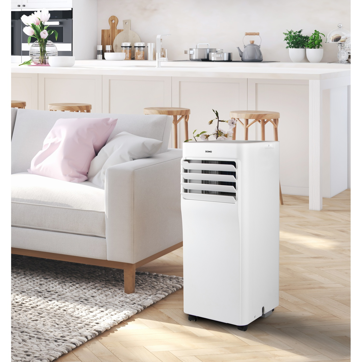 A white portable air conditioner next to a white sofa in a modern living area.