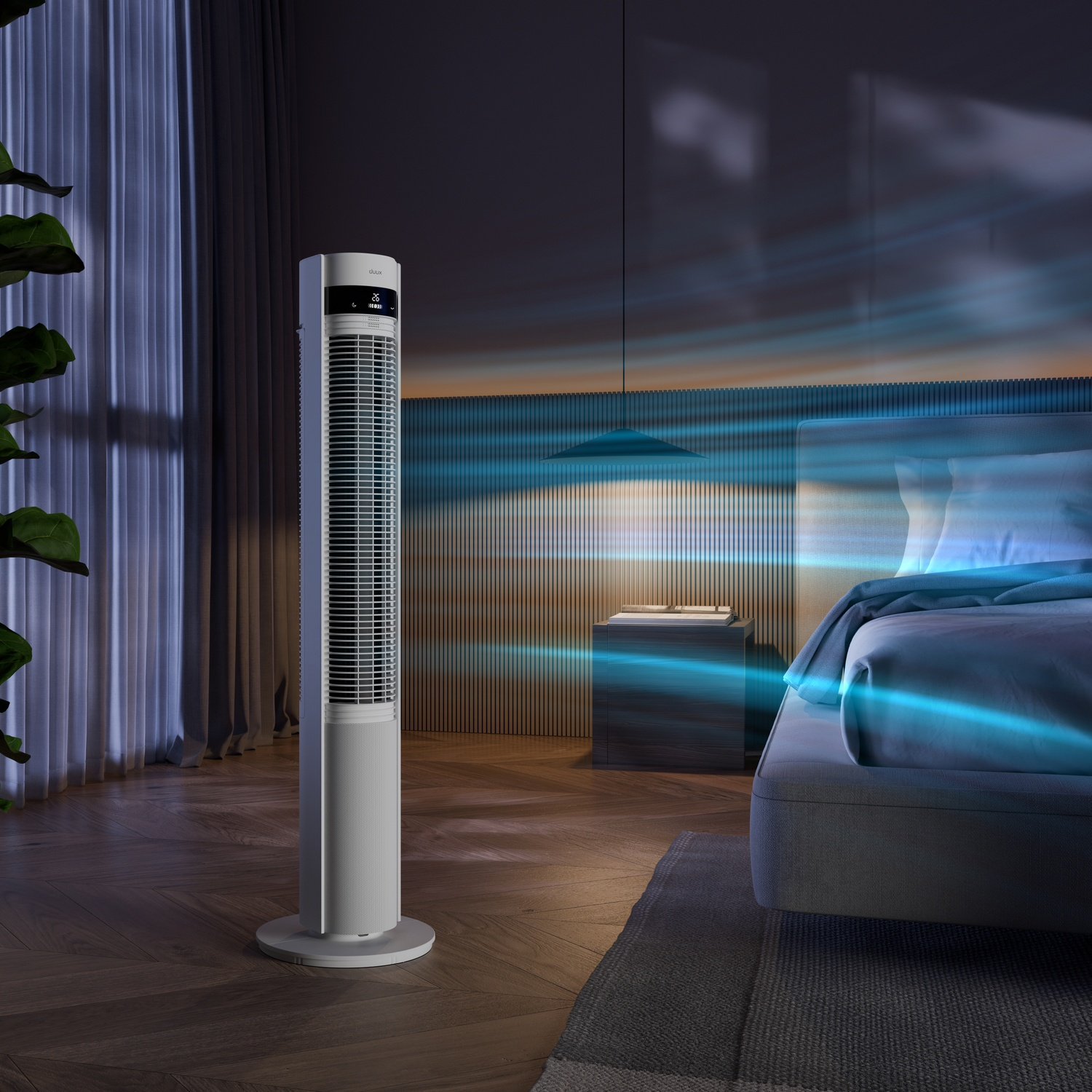 A white tower fan stands in a bedroom next to a bed. Blue air streams.