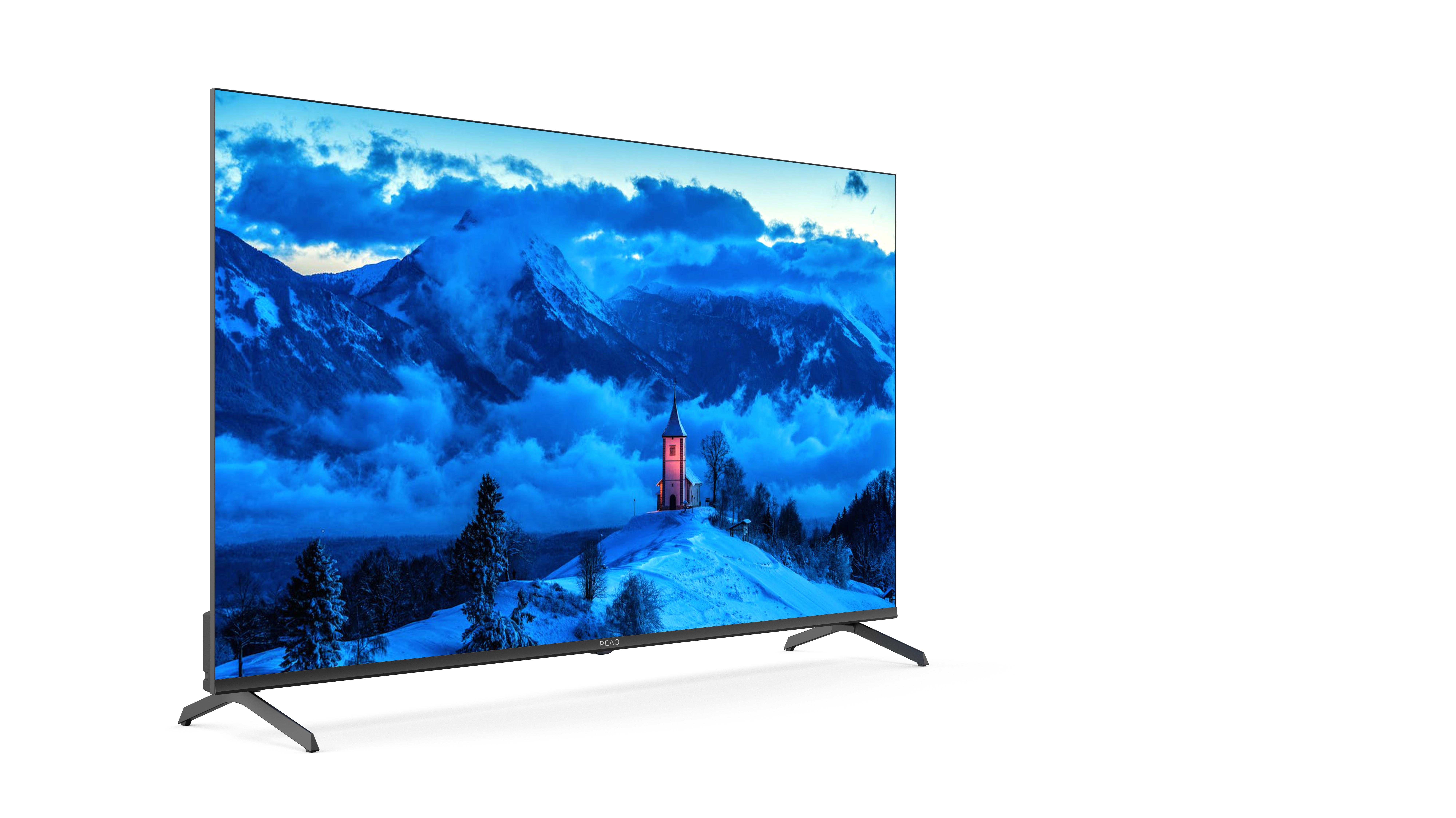 Nowoczesny telewizor wyświetla ośnieżony krajobraz górski z kościołem.