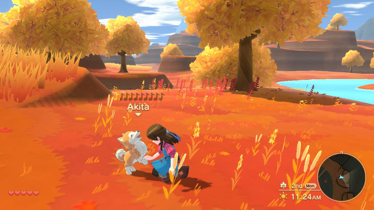 Ein Mädchen mit einem Hund in einer Herbstlandschaft mit gelben Bäumen.