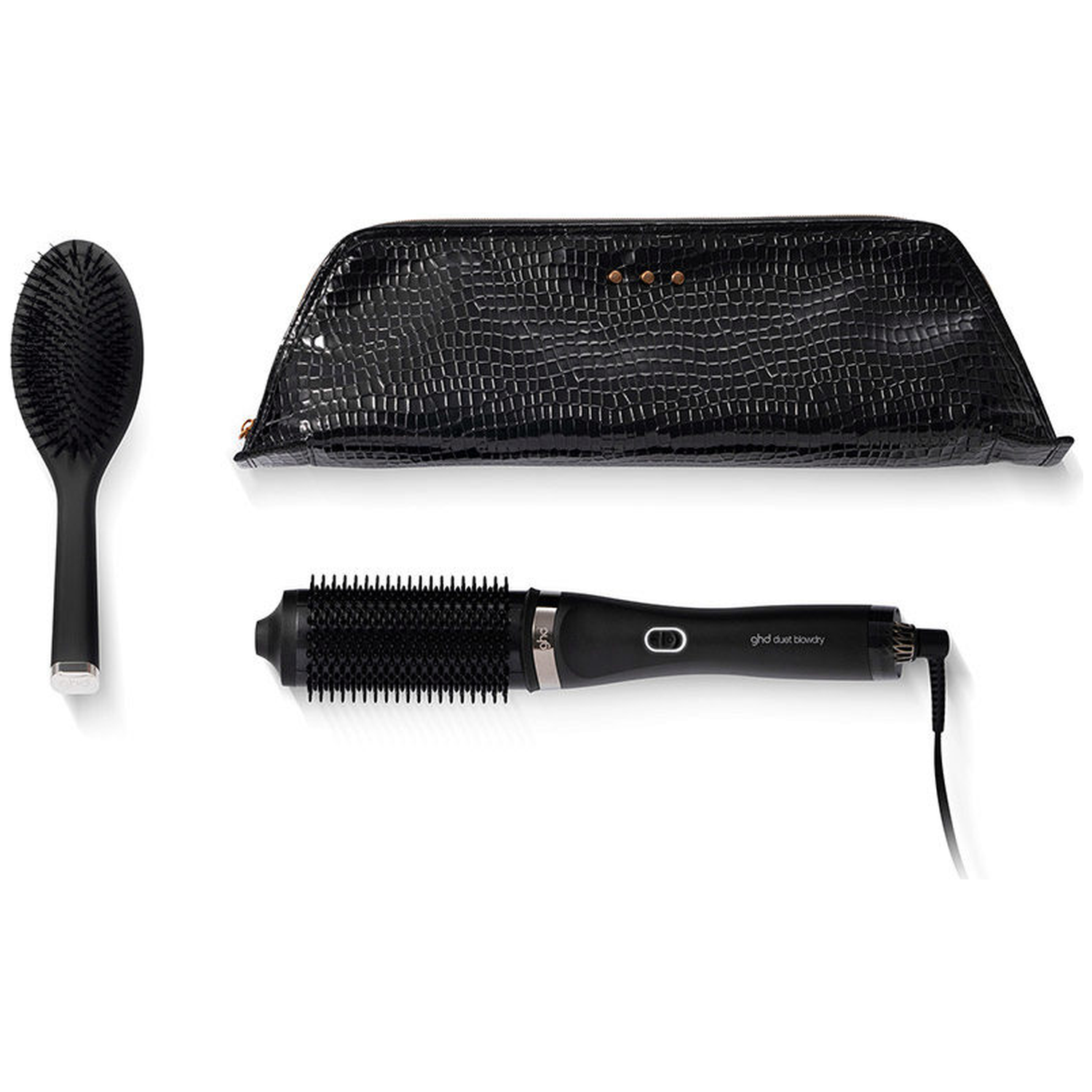 Black hair dryer, brush, and crocodile-patterned cosmetic bag.