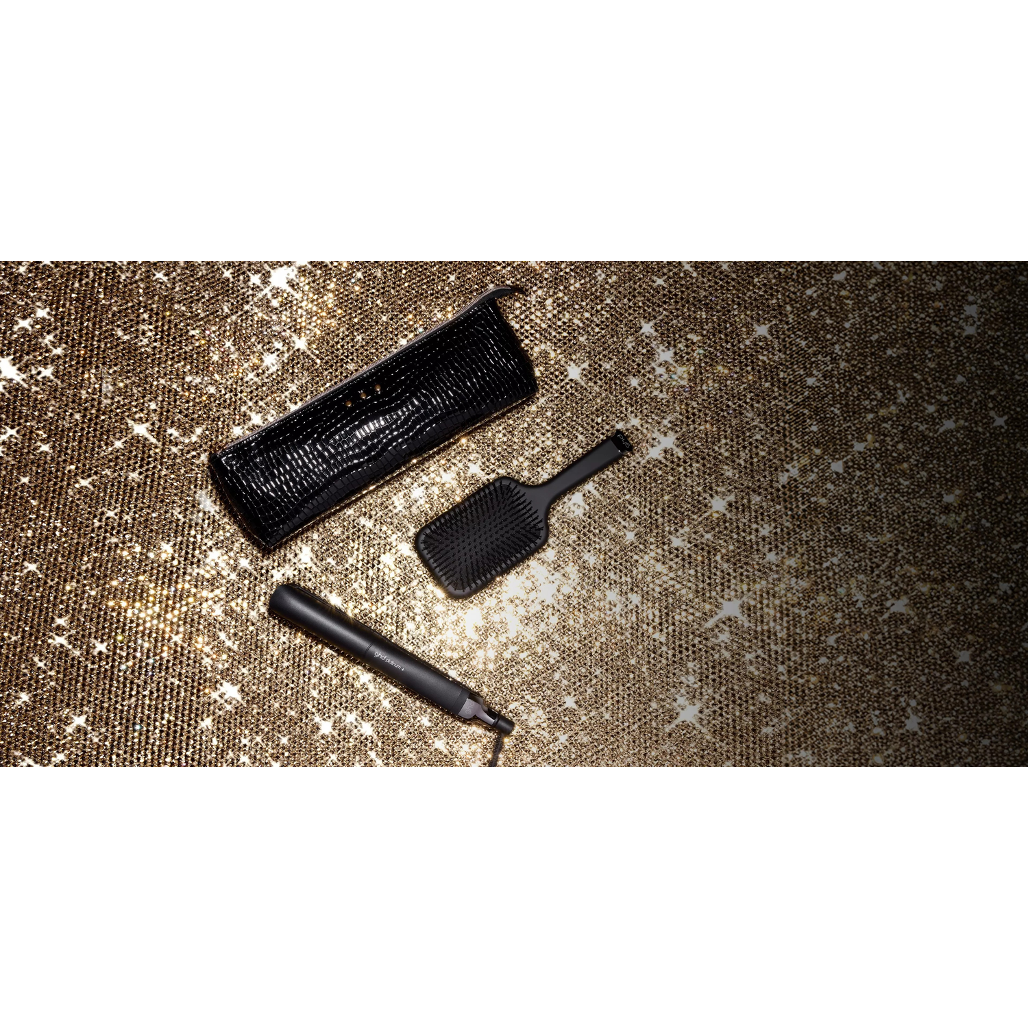 Black hair care set on a sparkly gold background.