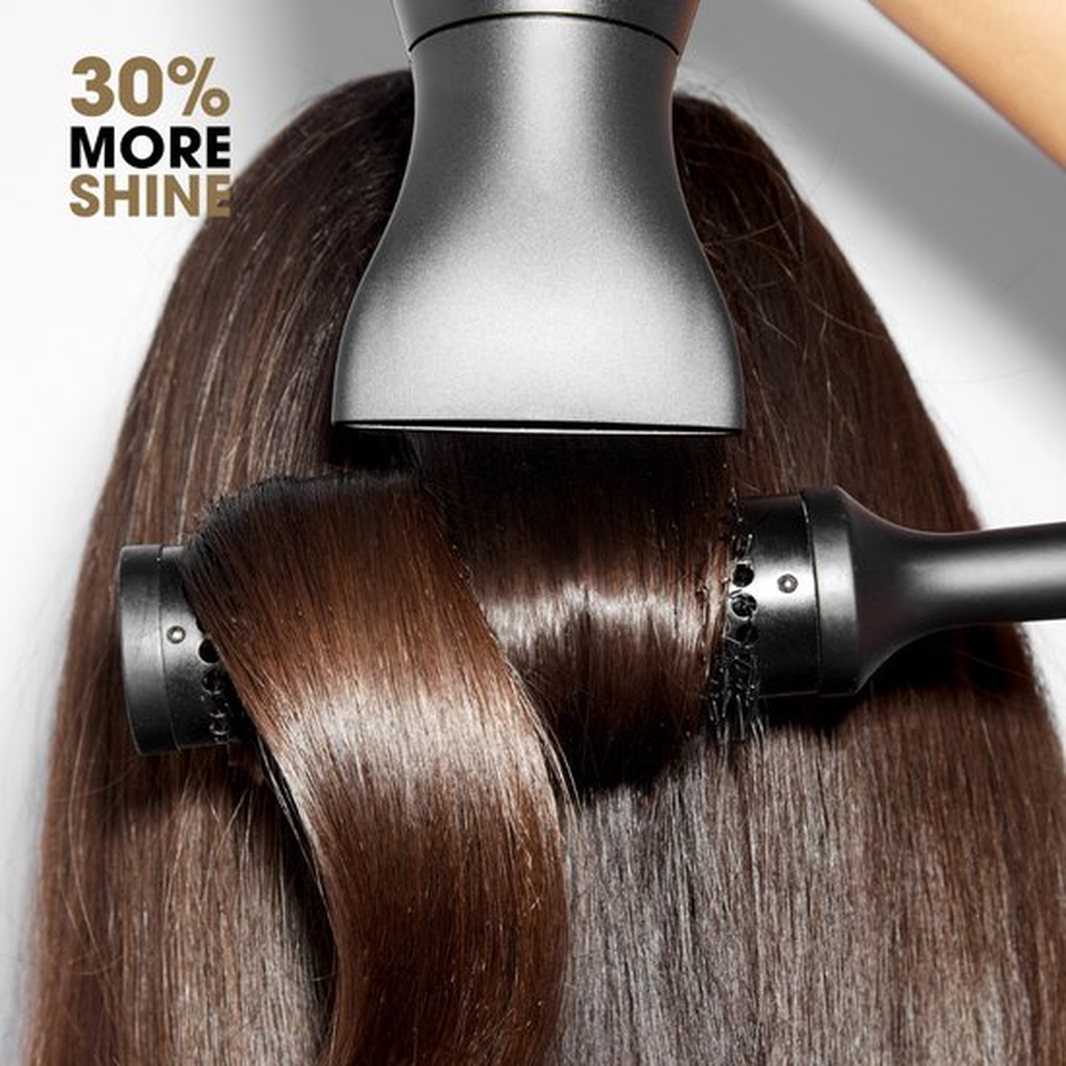 Donker haar wordt gestyled met föhn en borstel, met tekst "30% meer glans".
