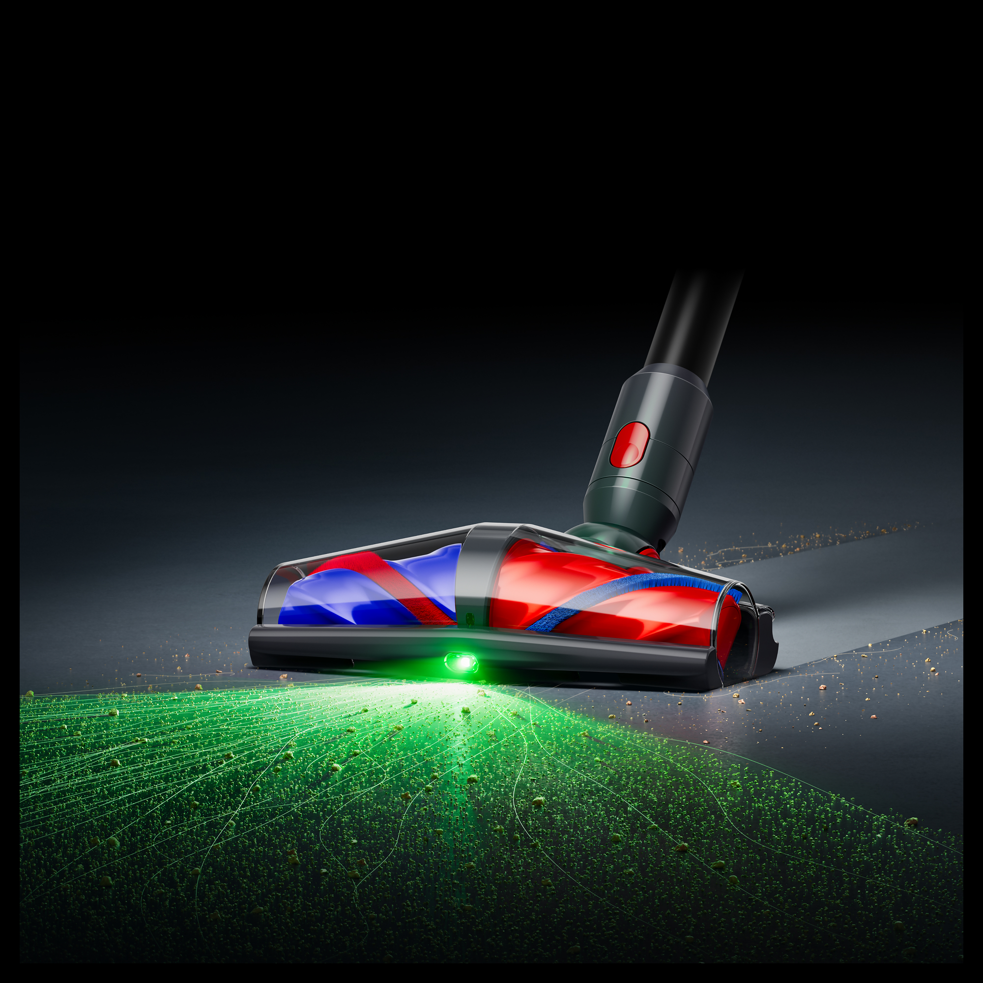 Staubsaugerdüse mit grüner LED beleuchtet Staubpartikel auf dem Boden.