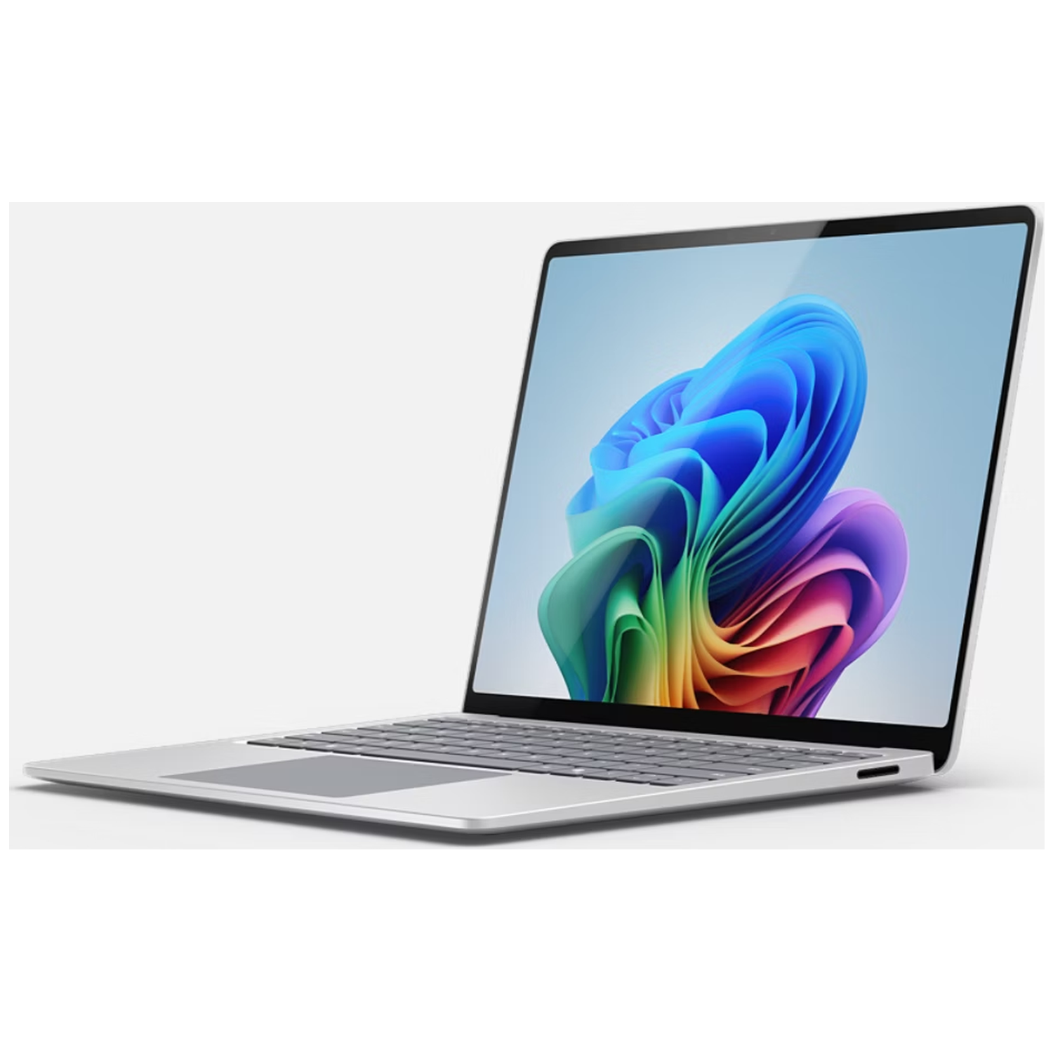 A silver laptop displaying a colorful, abstract wallpaper on its screen.