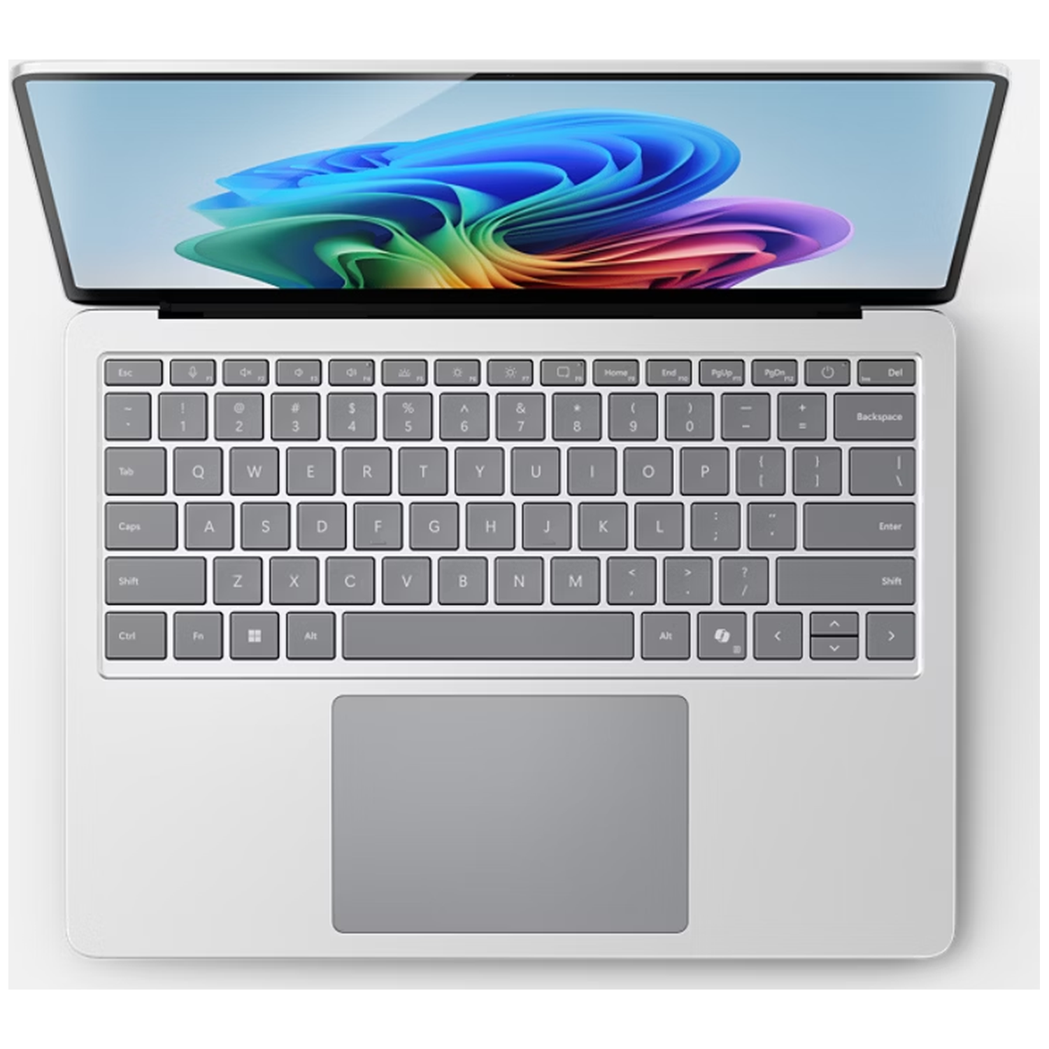 A silver laptop is open, showing a colorful abstract wallpaper on its screen and a full keyboard.