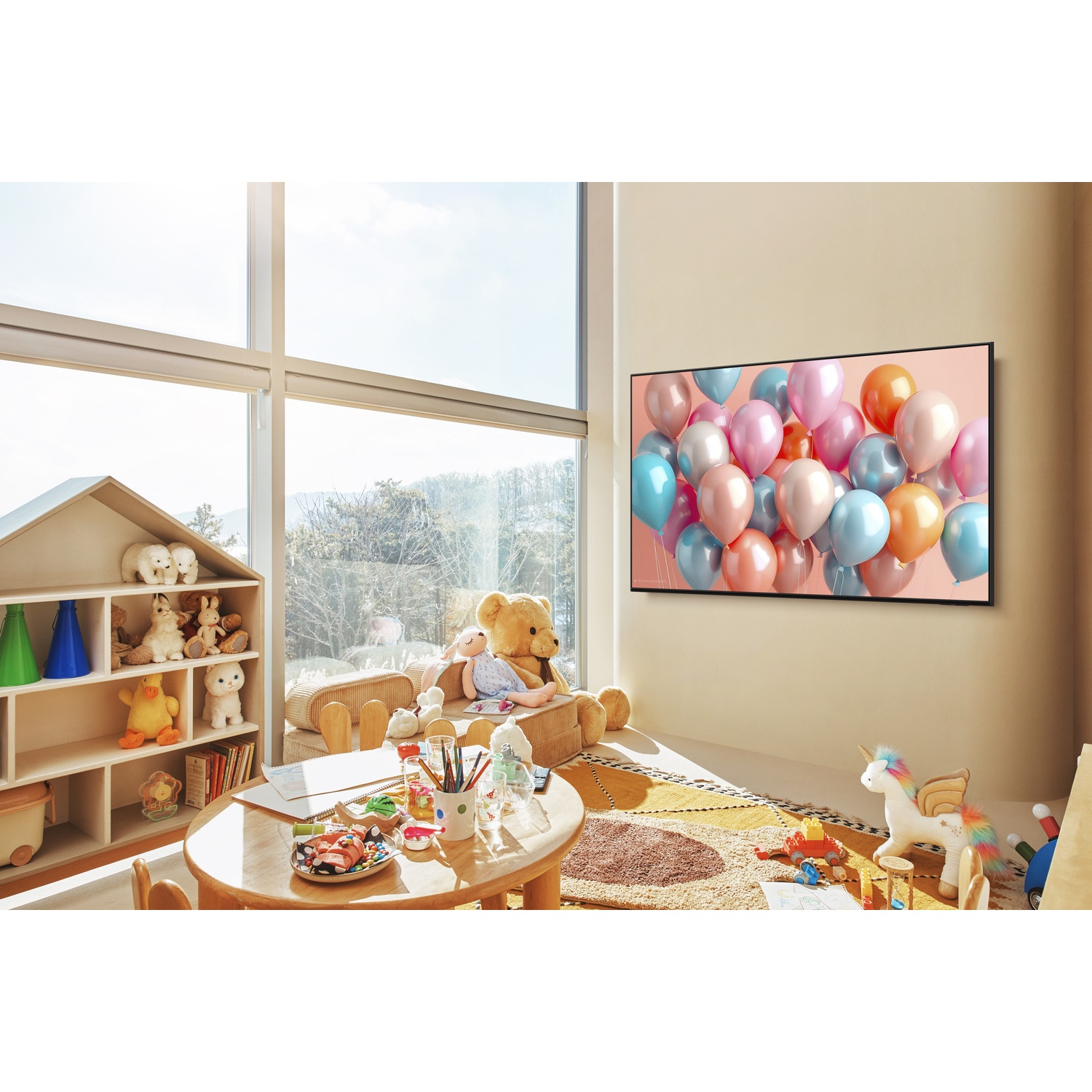 A child's room with toys, a bookshelf, and a TV displaying balloons.