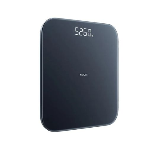 Una báscula personal digital oscura con pantalla iluminada que muestra 52,60.