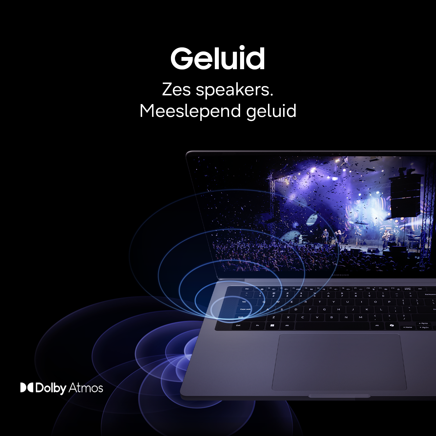 Laptop displays concert with confetti, Dolby Atmos logo bottom left.
