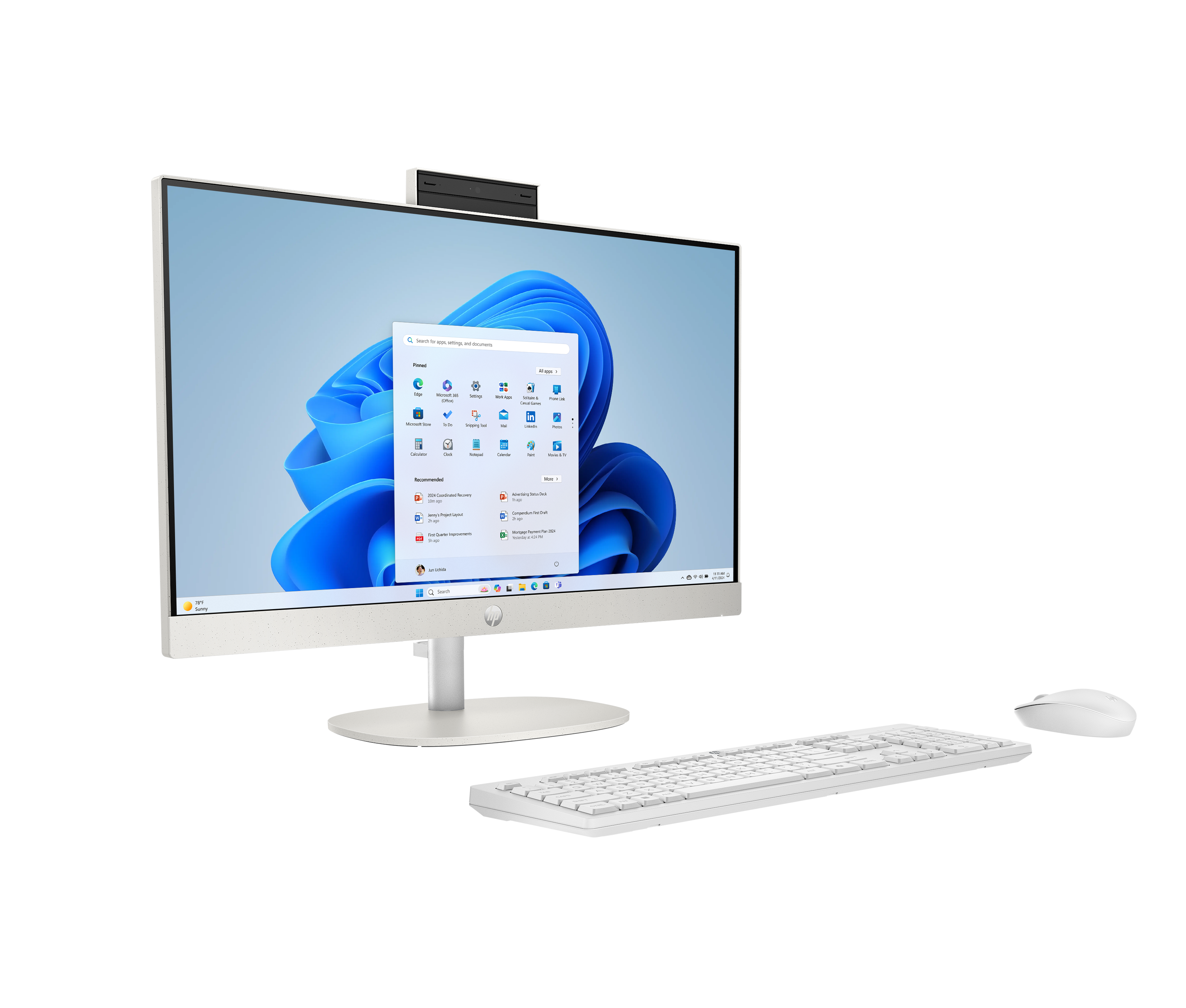 Een witte all-in-one computer met toetsenbord en muis op zwarte achtergrond.