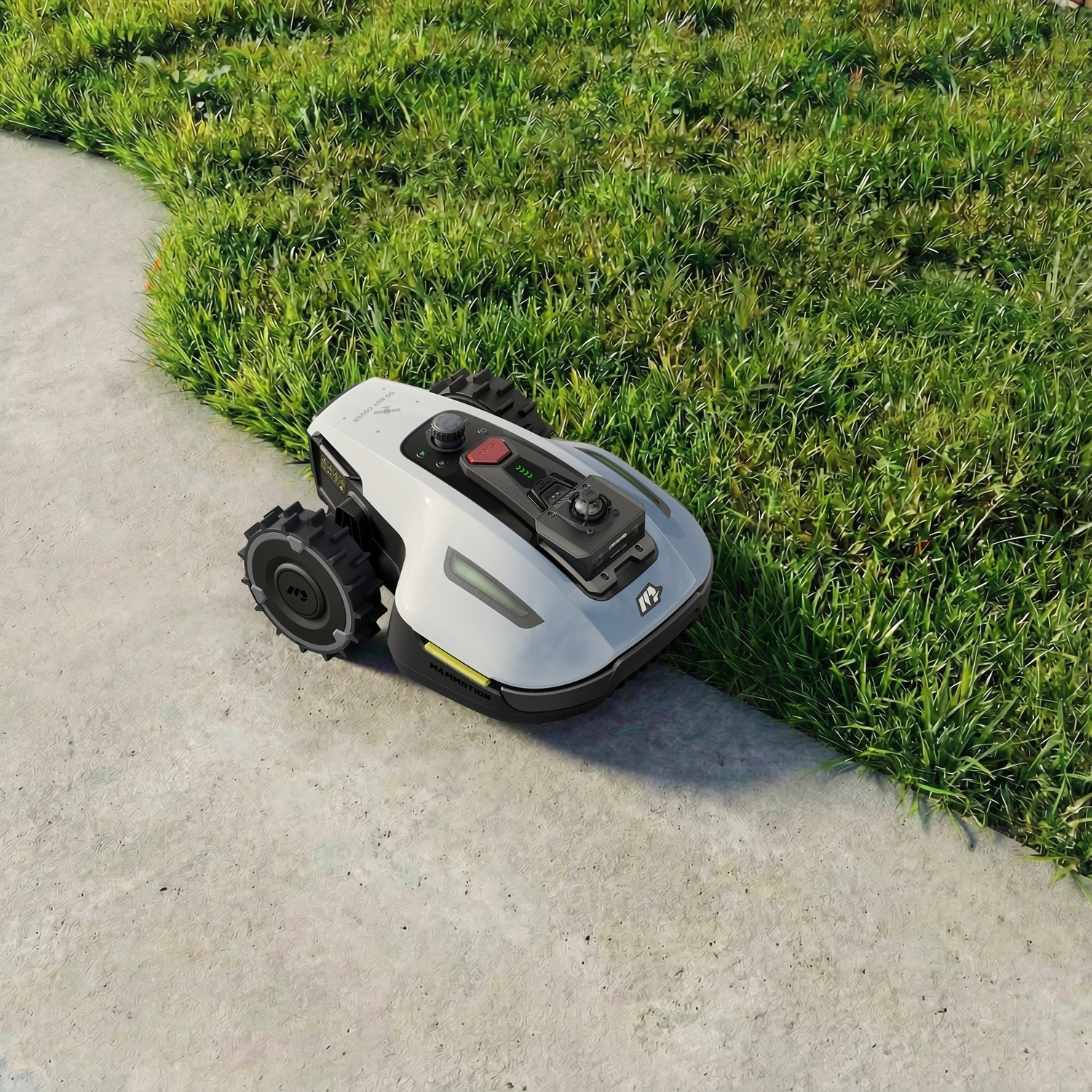 Un robot tosaerba bianco è su un sentiero di cemento accanto a erba verde.