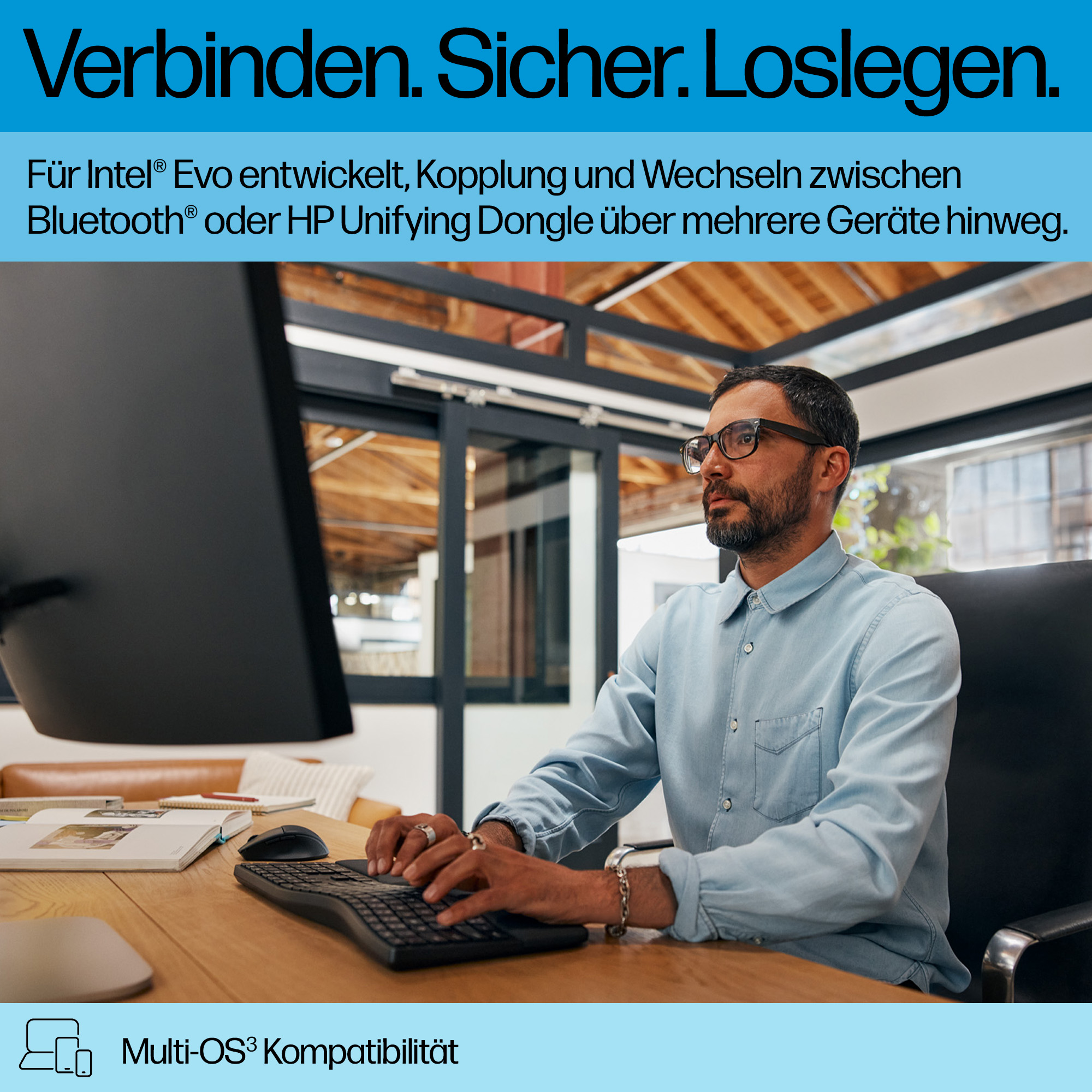 Mann tippt auf Tastatur, Laptop und Maus auf Schreibtisch. Multi-OS-Kompatibilität.