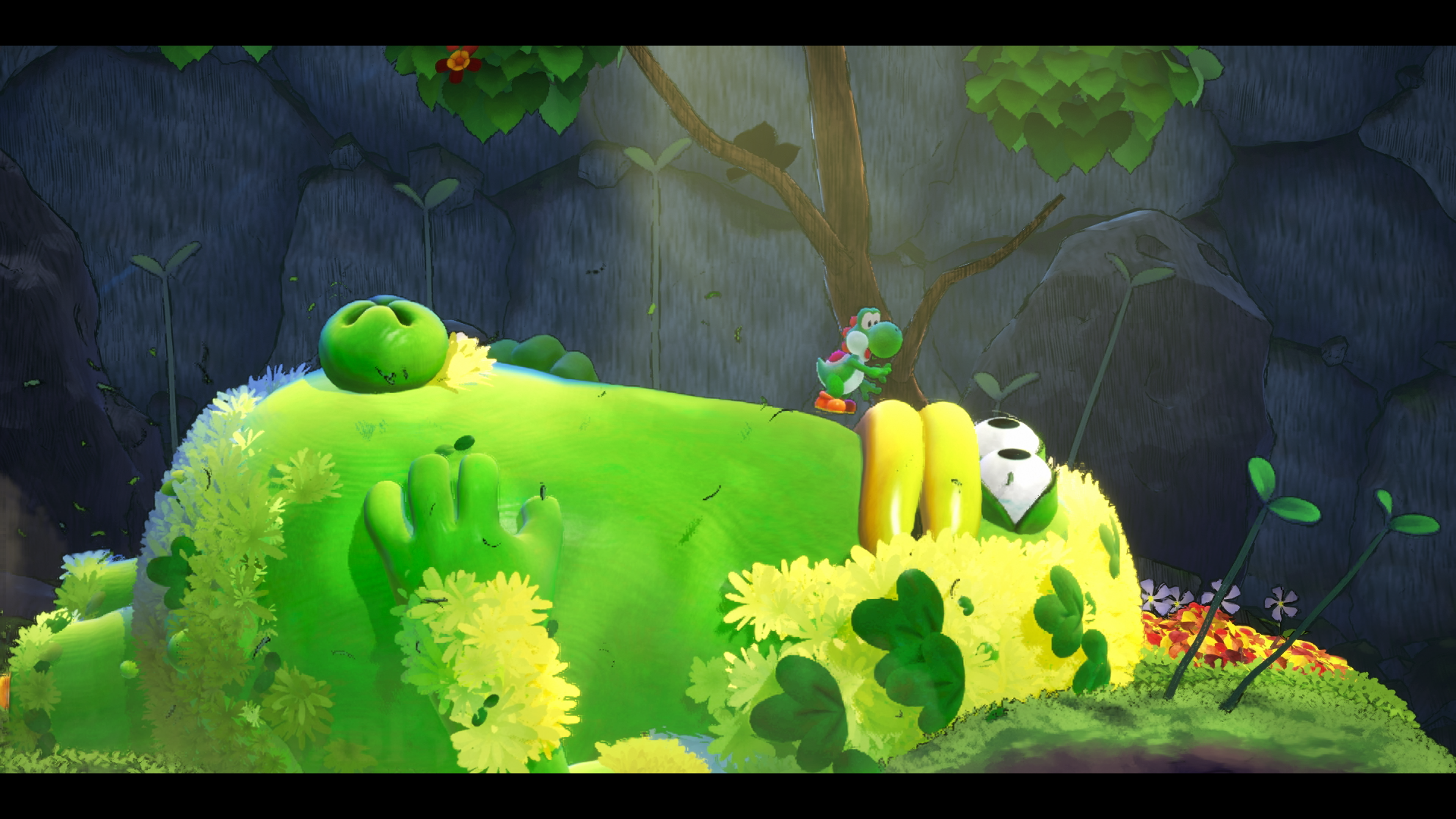 Yoshi sur une créature verte géante couverte de fleurs.