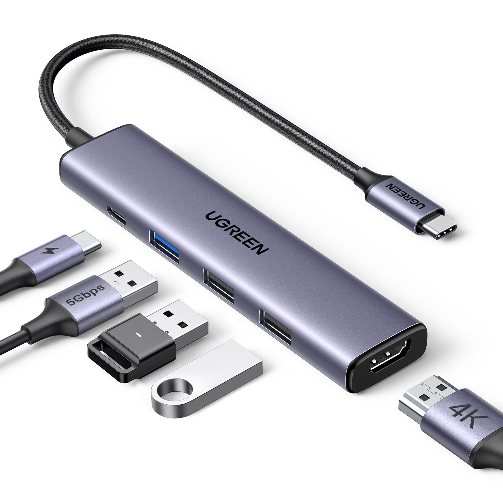 Grauer USB-C-Hub mit Anschlüssen und angeschlossenen USB-Laufwerken und Kabeln.