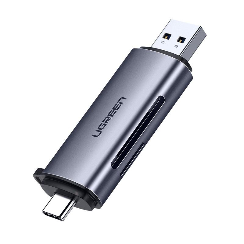 Ein grauer UGREEN USB-C Hub mit USB-A und USB-C Anschlüssen auf weißem Grund.