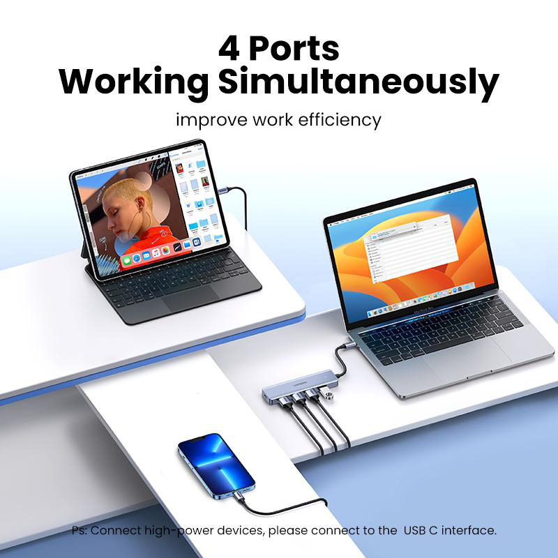Ein Laptop, Tablet und Smartphone sind über einen USB-C-Hub verbunden.