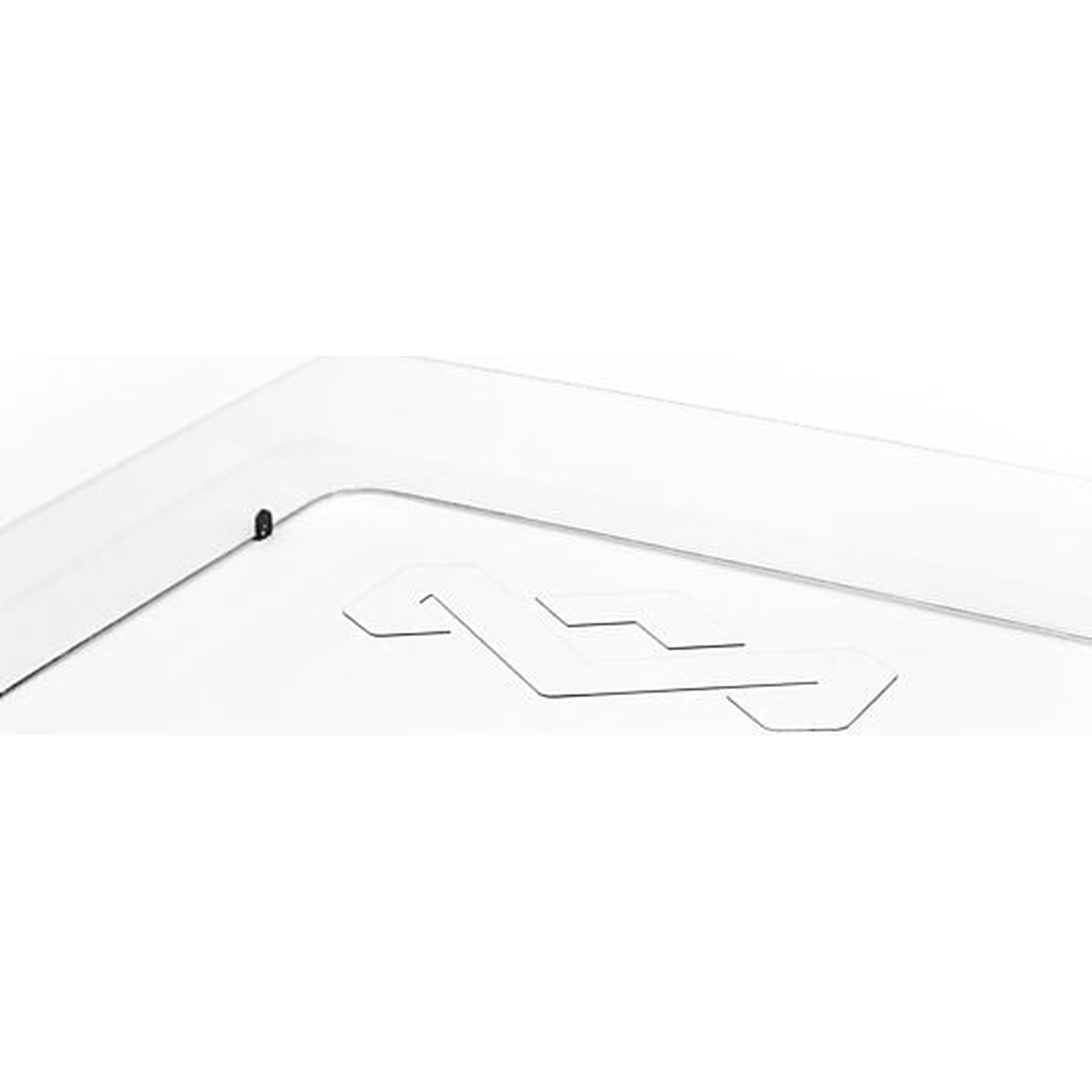 A white object with an embossed logo. A small black dot is visible.