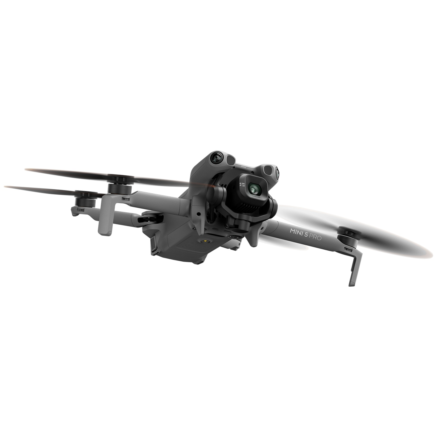 Gray DJI Mini 5 Pro drone flying with spinning propellers.
