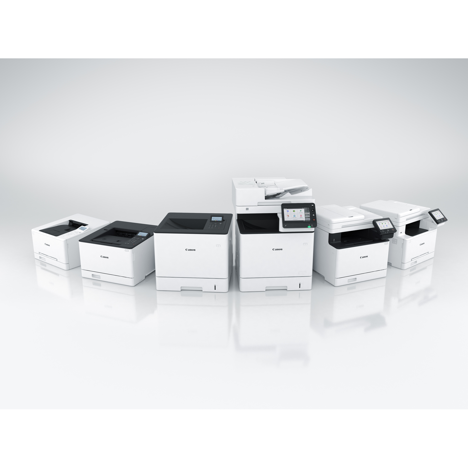 Several white Canon printers are arranged in a row on a reflective surface.
