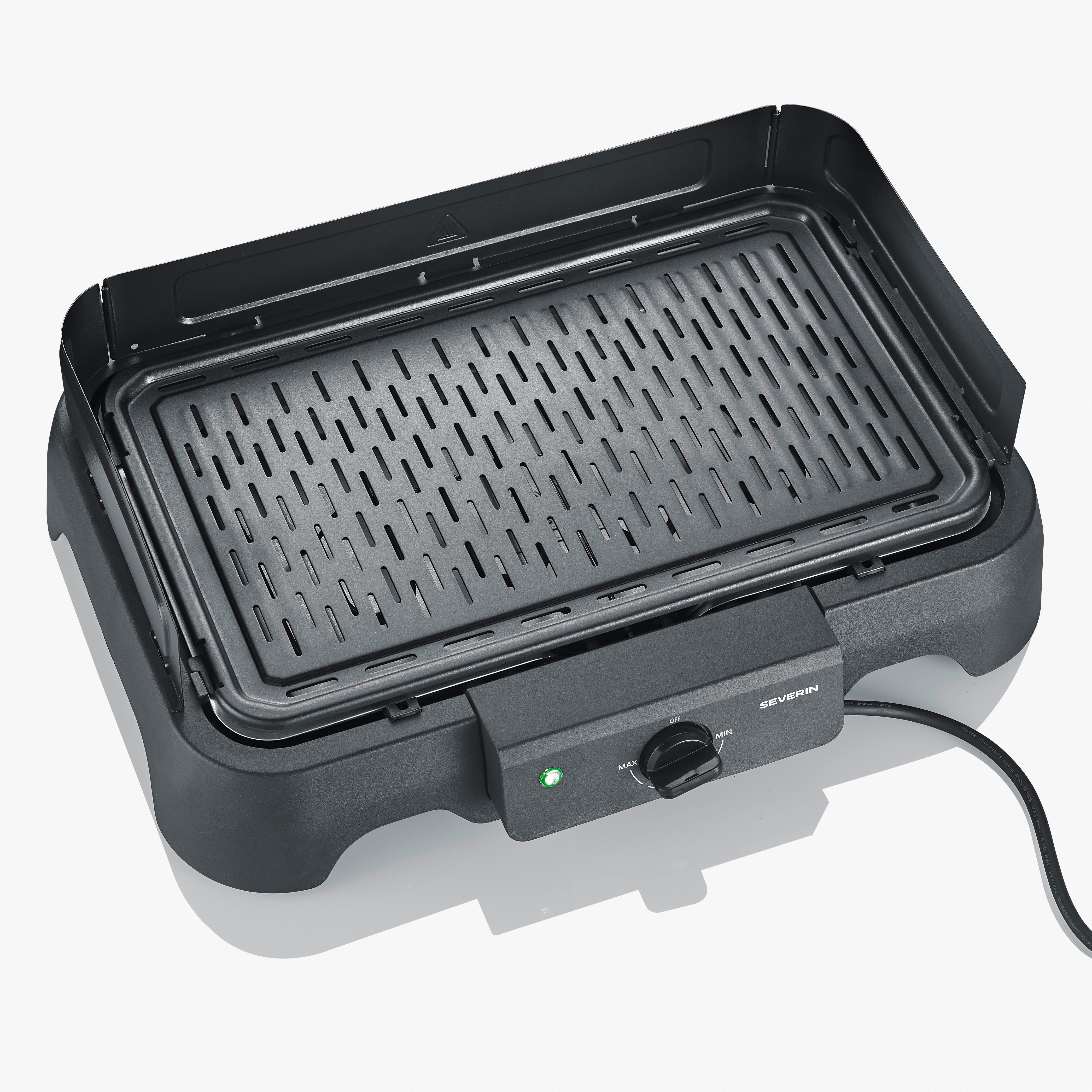 Elektrischer Tischgrill mit schwarzem Gehäuse und Grillrost. Ein Drehregler und eine grüne Leuchte.