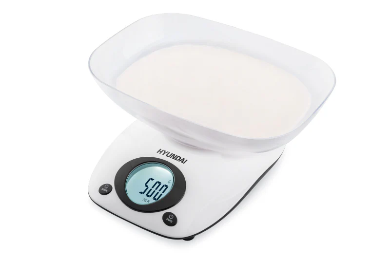 Fehér digitális konyhai mérleg tálval, fehér porral töltve. A kijelző 500g-ot mutat.