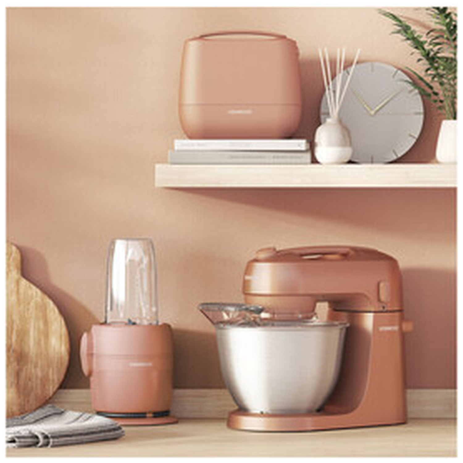 Pink kitchen appliances: stand mixer, blender, and a toaster on a shelf.