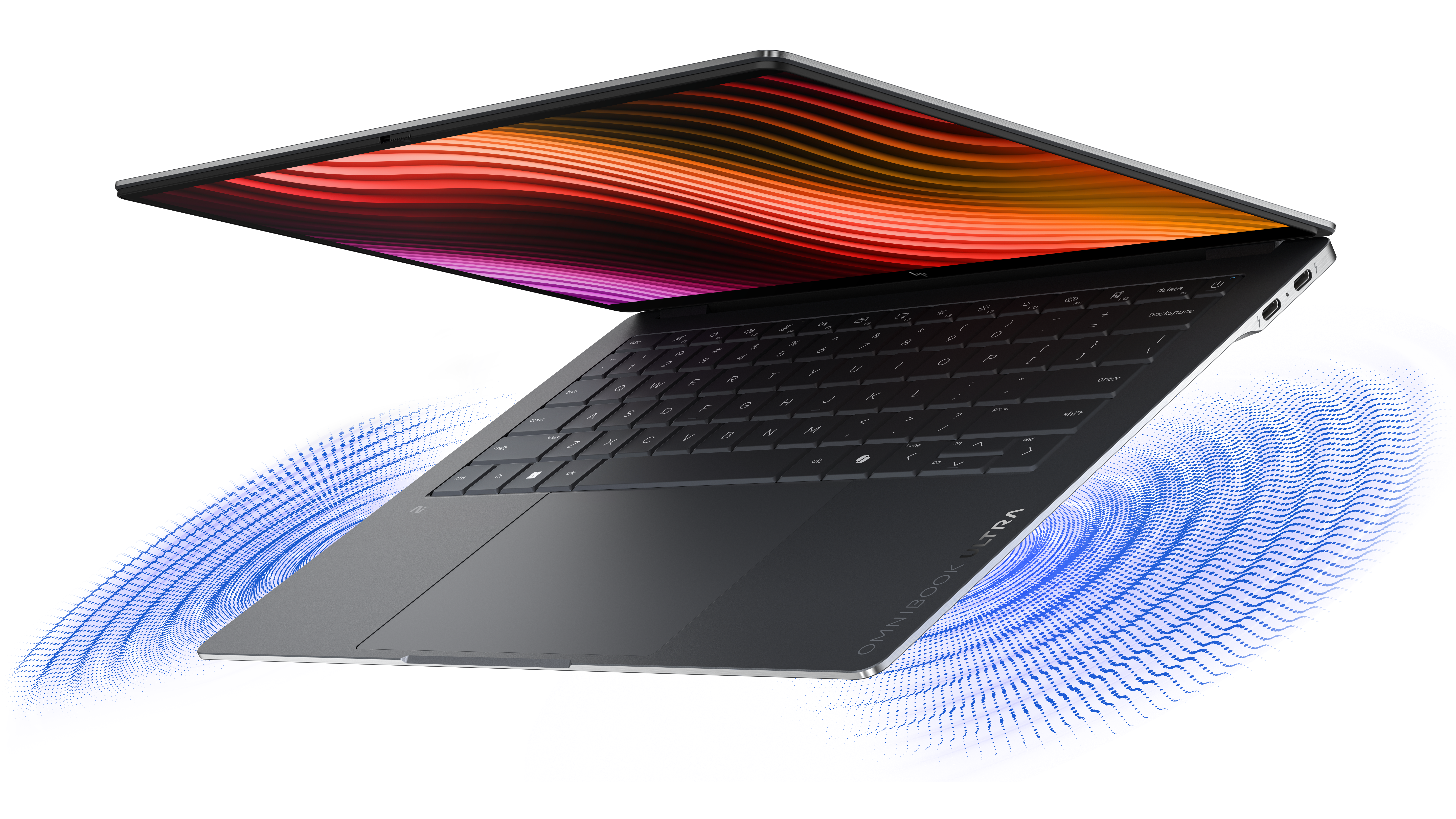 Otwarty laptop wyświetla kolorowy ekran z niebieskimi falami.