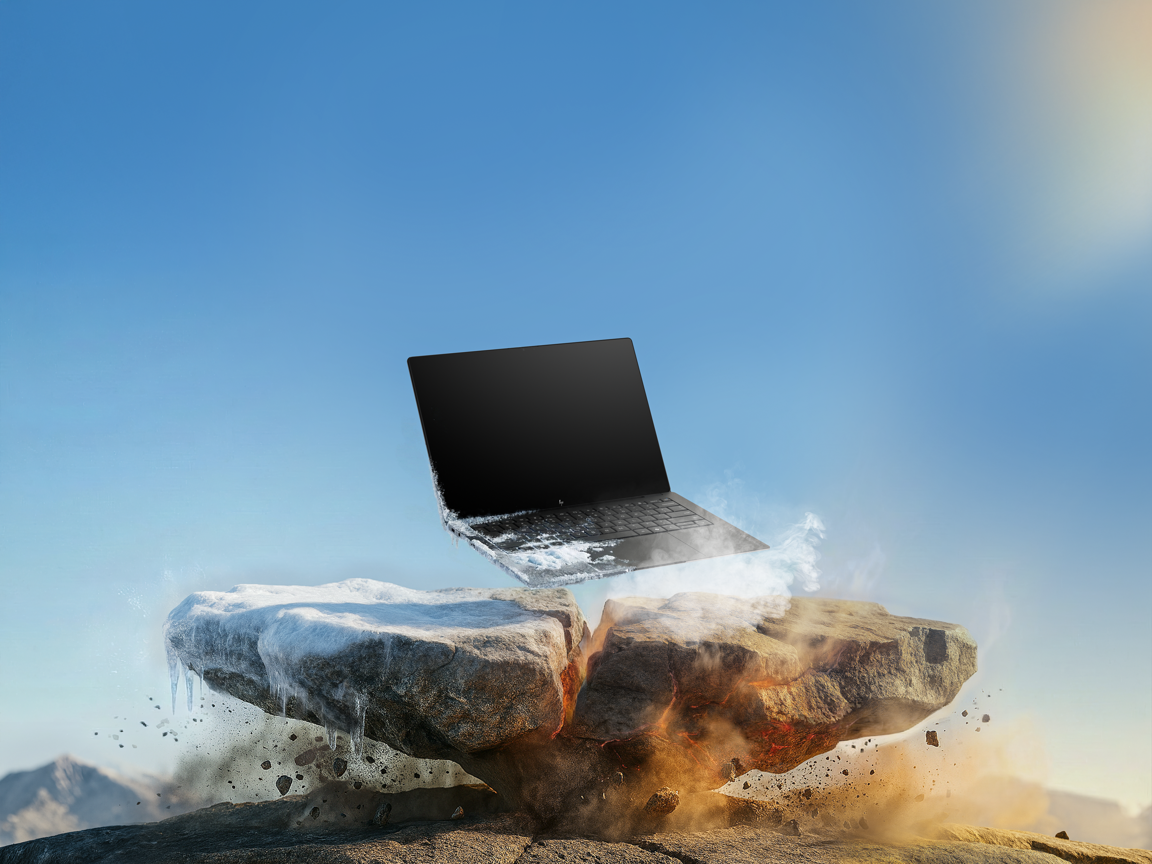 Laptop unosi się nad pękniętymi skałami, częściowo pokrytymi lodem i ogniem.