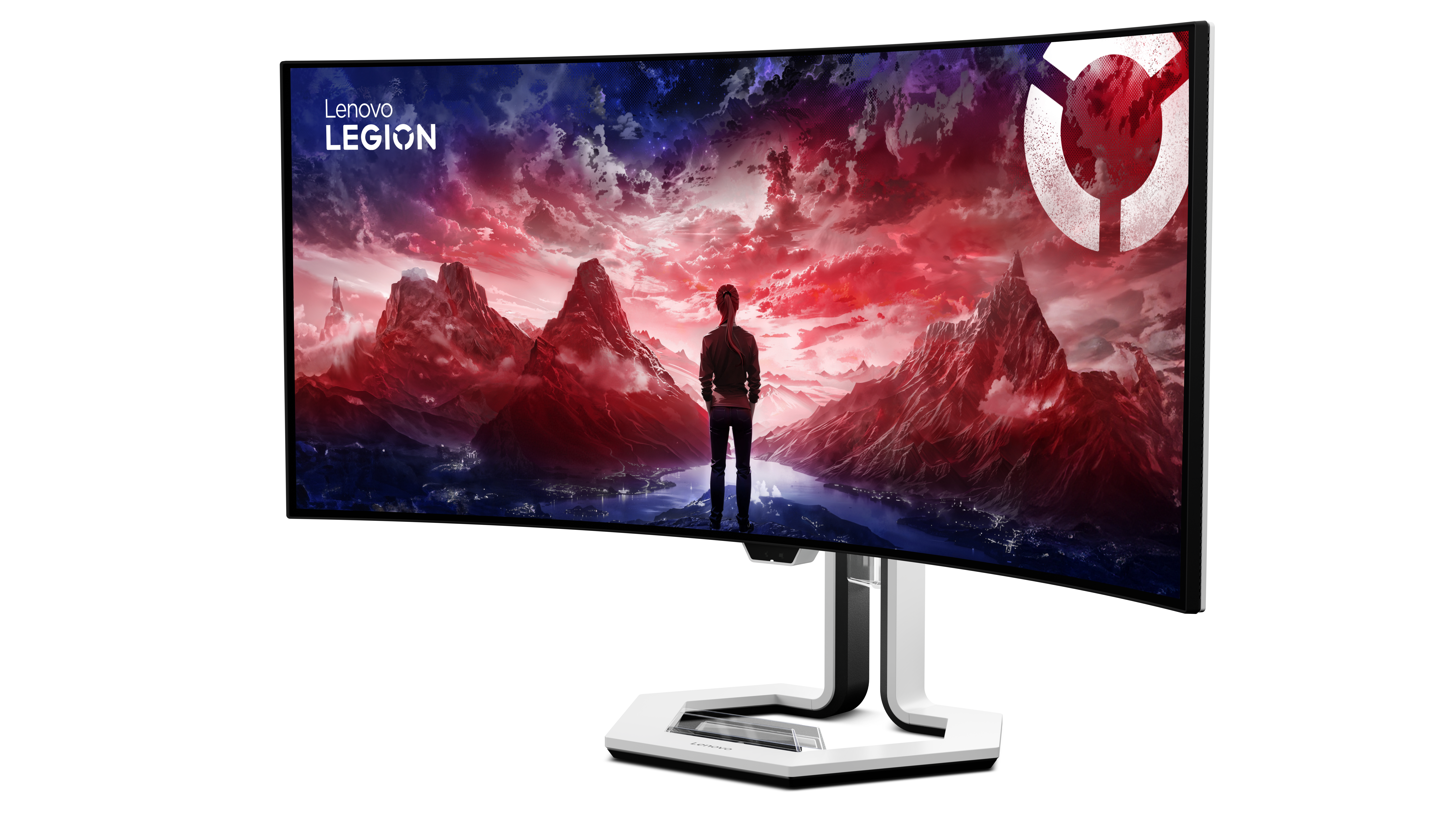 Zakrzywiony monitor Lenovo Legion wyświetla dramatyczny krajobraz z czerwonymi górami i mężczyzną.